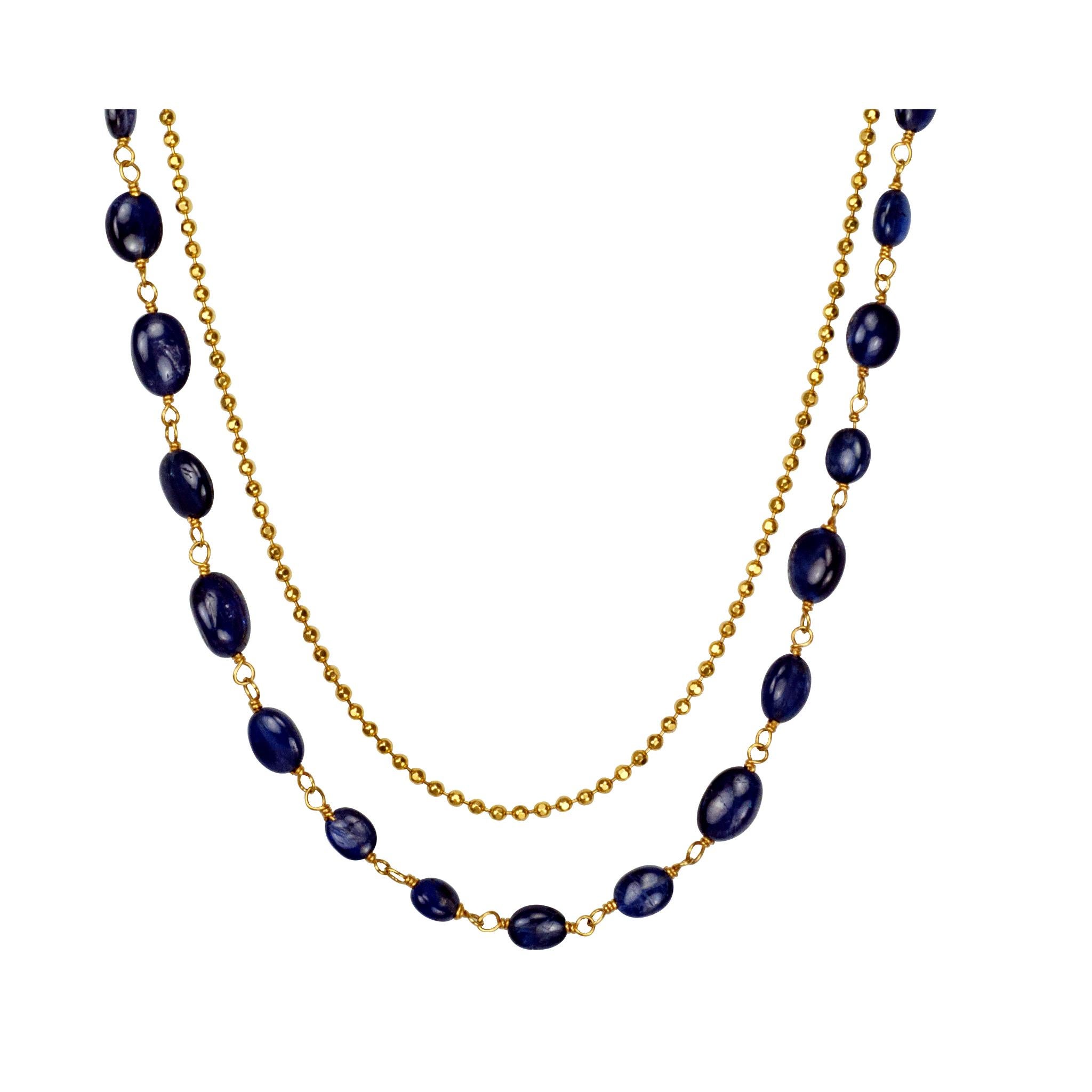 Layered 18 inch Blue Sapphire Cabochon Bead and 14K Yellow Gold Chain Necklace. This multi-strand necklace features vivid round faceted blue sapphire beads. Great Layering piece for everyday. Wear with your favorite pair of jeans.

Blue sapphire is