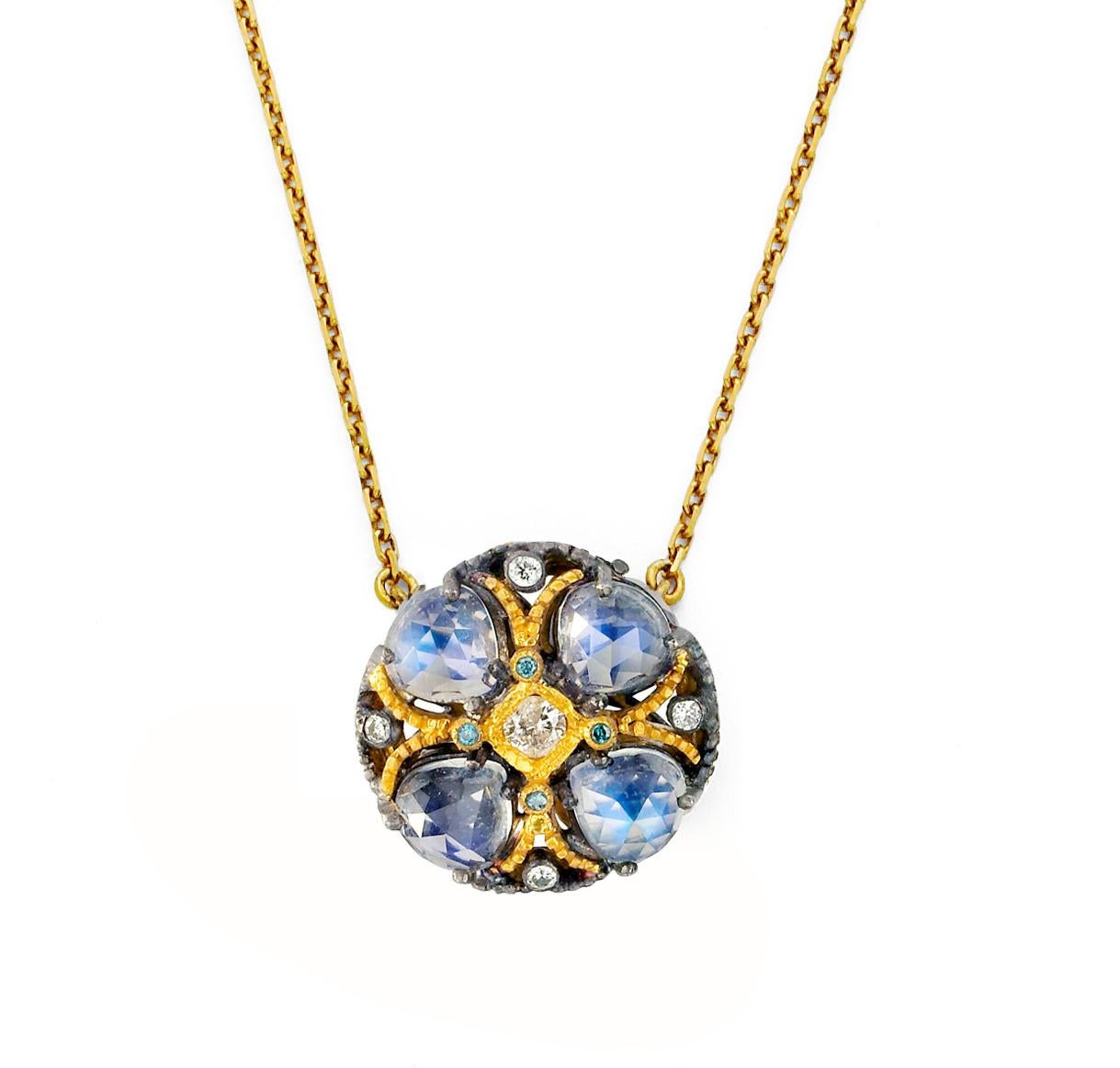 Blackened silver and 18K gold poppy flower shaped pendant with rose cut Moonstone 3.00cts and Teal and White Diamonds 0.29cts and 14K yellow gold chain.

Moonstone’s unearthly glow is caused by light scattering between microscopic layers of