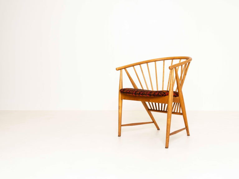 Nice 'Sunfeather' Chair by Sonna Rosen, Sweden 1950s. This iconic vintage lounge chair is an example of Scandinavian craftsmanship. The shape and spines of the back of the chair represent a rising sun or sunbeam. It is in good condition with a newly
