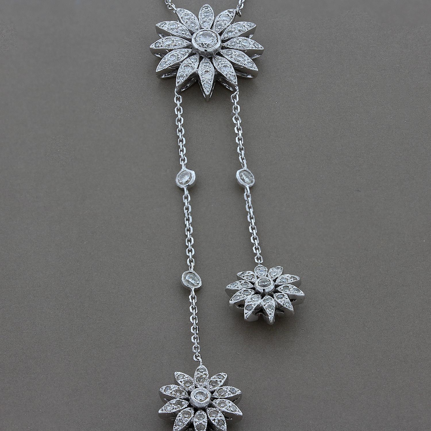This ultra-feminine necklace features three sunflower drops. 1.16 carats of round cut diamonds are in the finely detailed sunflowers and in the diamond by the yard style chain for extra brilliance. Set in 18K white gold.

Necklace Length: 16
