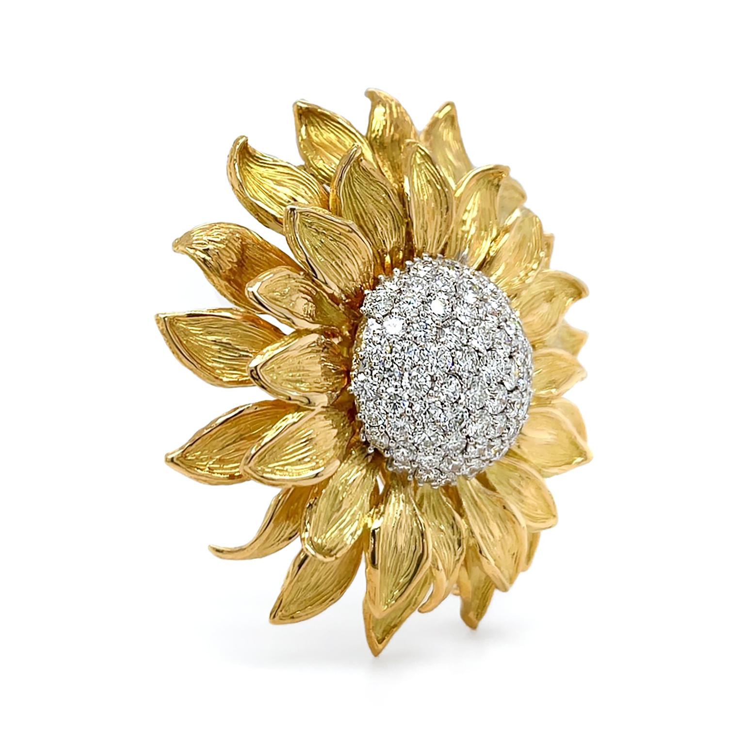 White diamonds and gold combine to produce a brilliant glow to this brooch. 18k yellow gold enlivens a sunflower motif, featuring two overlapping rows of textured petals. The artisanship ensures no two petals are alike by subtle differences in their
