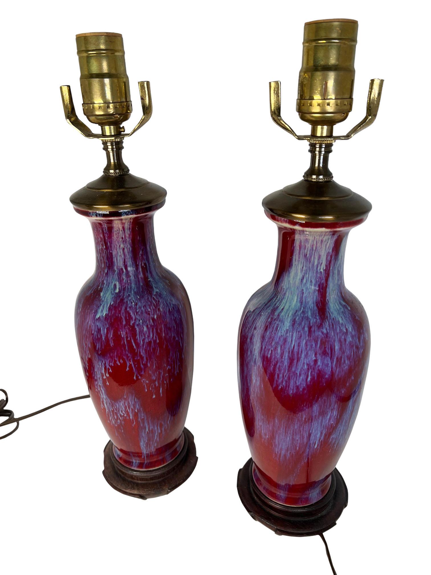 A pair of sung de boeuf vases converted into lamps with wood bases. 20th century China.