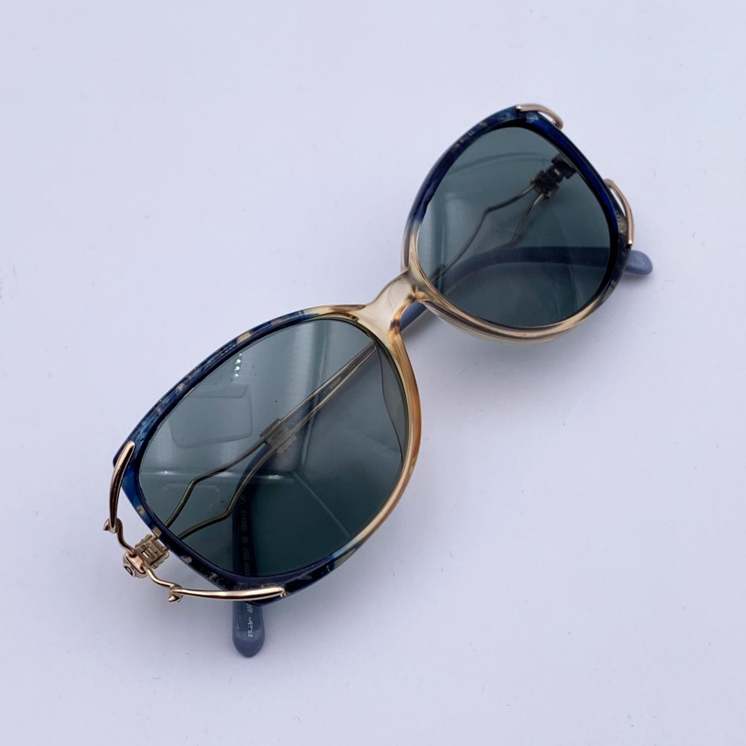 Vintage Christian Dior sunglasses, Mod. 2667 - Col 50. Clear and blue acetate front with gold metal ear stems. Original 100% Total UVA/UVB protection gradient lenses in light blue color. CD logo on temples. Made in Germany

Details

MATERIAL: