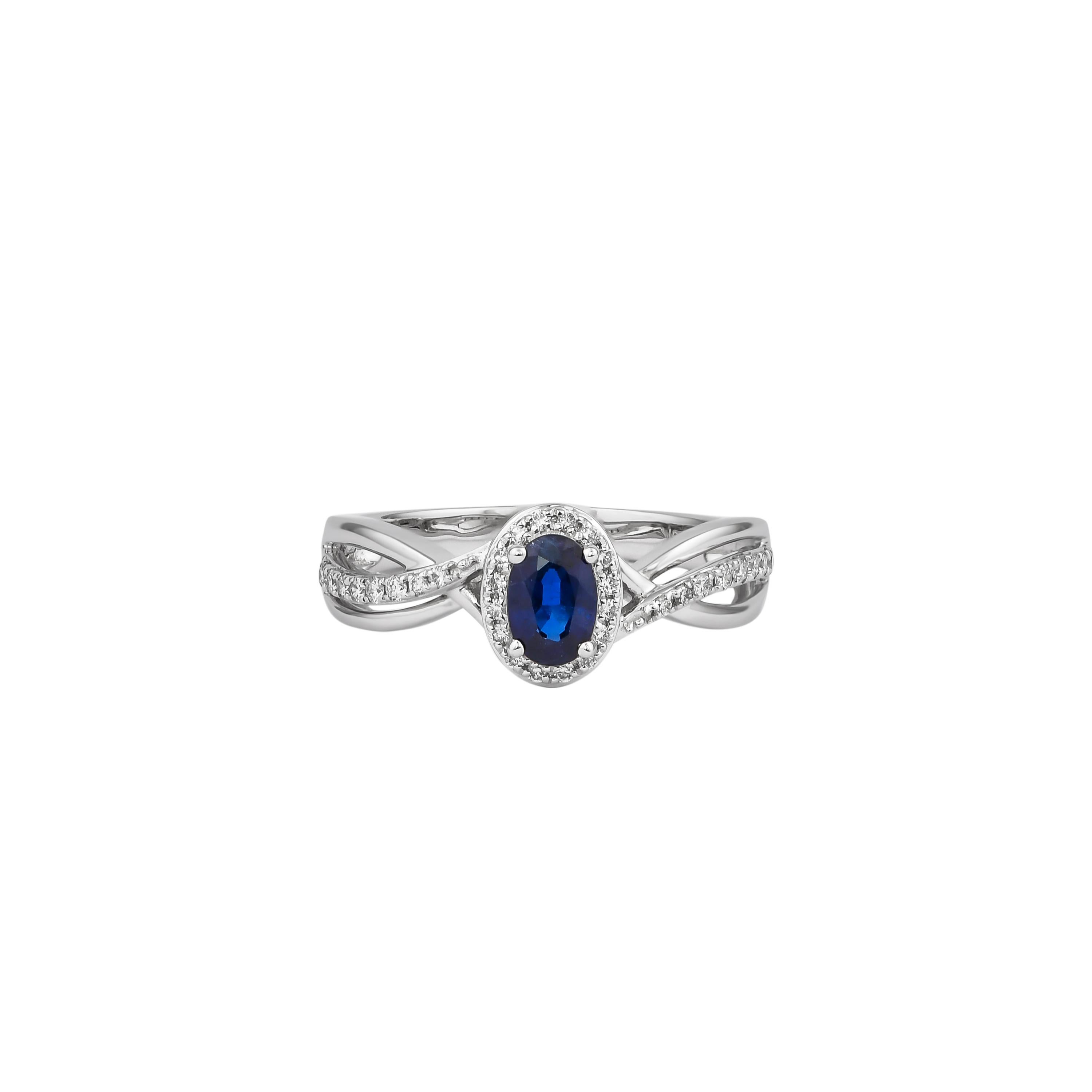 Elevate your elegance with this exquisite ring, crafted in luxurious 18K white gold. At its center, a captivating blue sapphire radiates deep, rich hues, surrounded by a halo of sparkling diamonds that enhance its brilliance. The intricate design