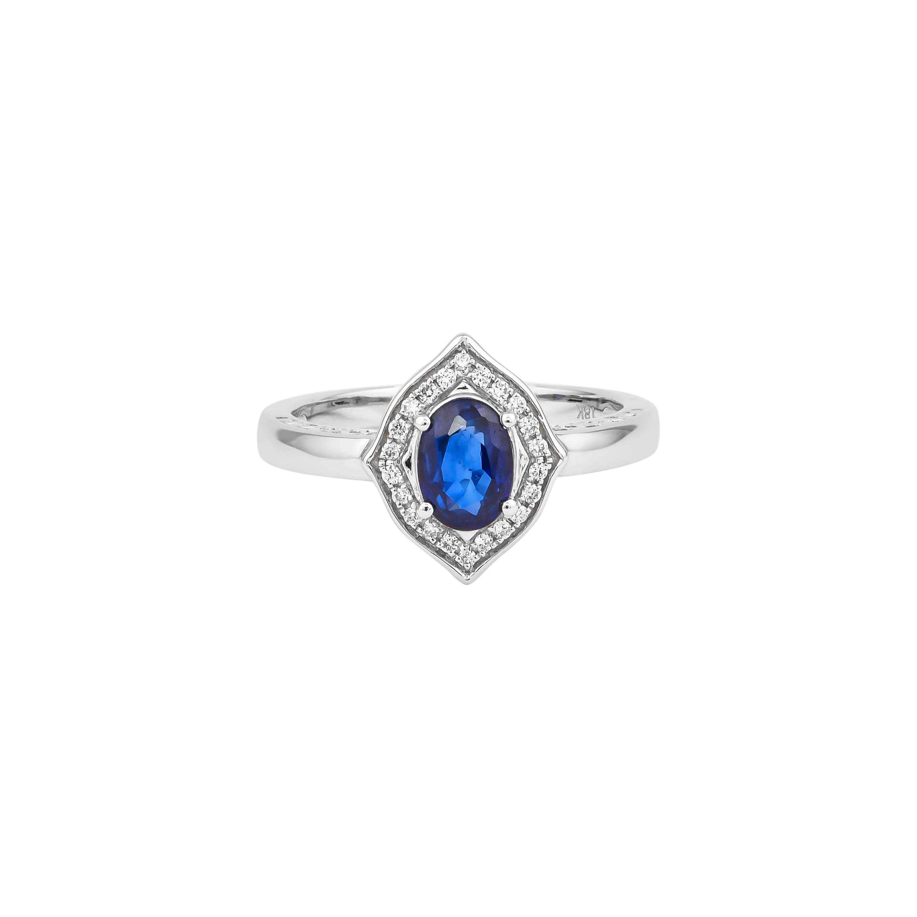 Elevate your elegance with this exquisite ring, crafted in luxurious 18K white gold. At its center, a captivating blue sapphire radiates deep, rich hues, surrounded by a halo of sparkling diamonds that enhance its brilliance. The intricate design