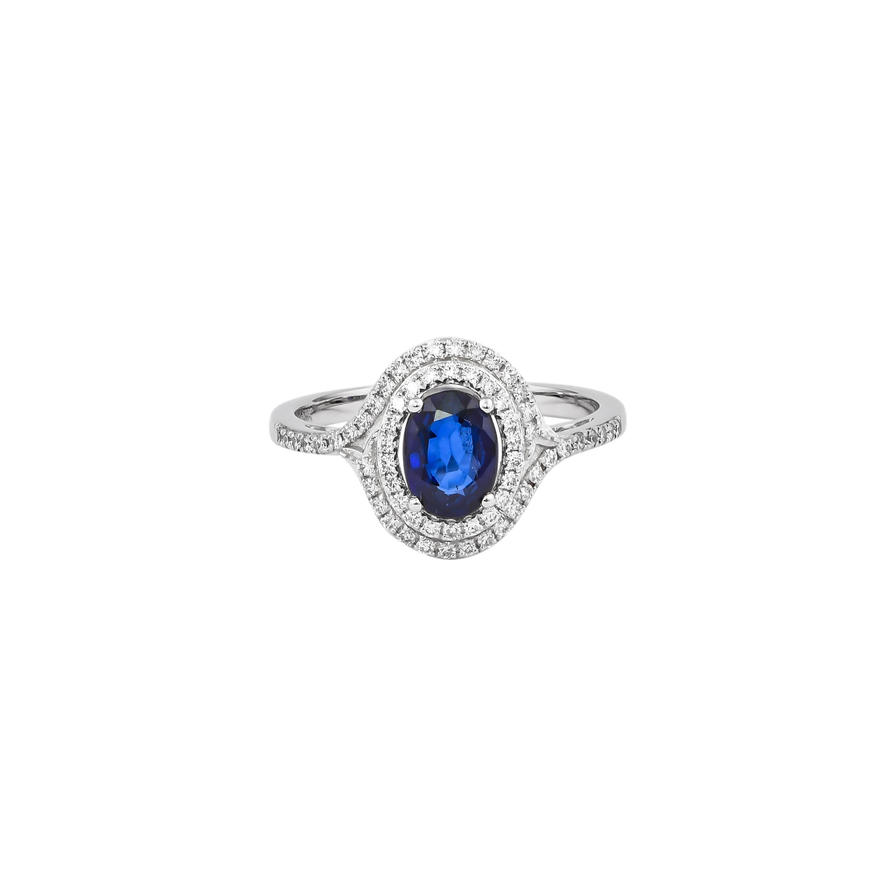 Elevate your elegance with this exquisite ring, crafted in luxurious 18K white gold. At its center, a captivating blue sapphire radiates deep, rich hues, surrounded by a halo of sparkling diamonds that enhance its brilliance. The intricate design