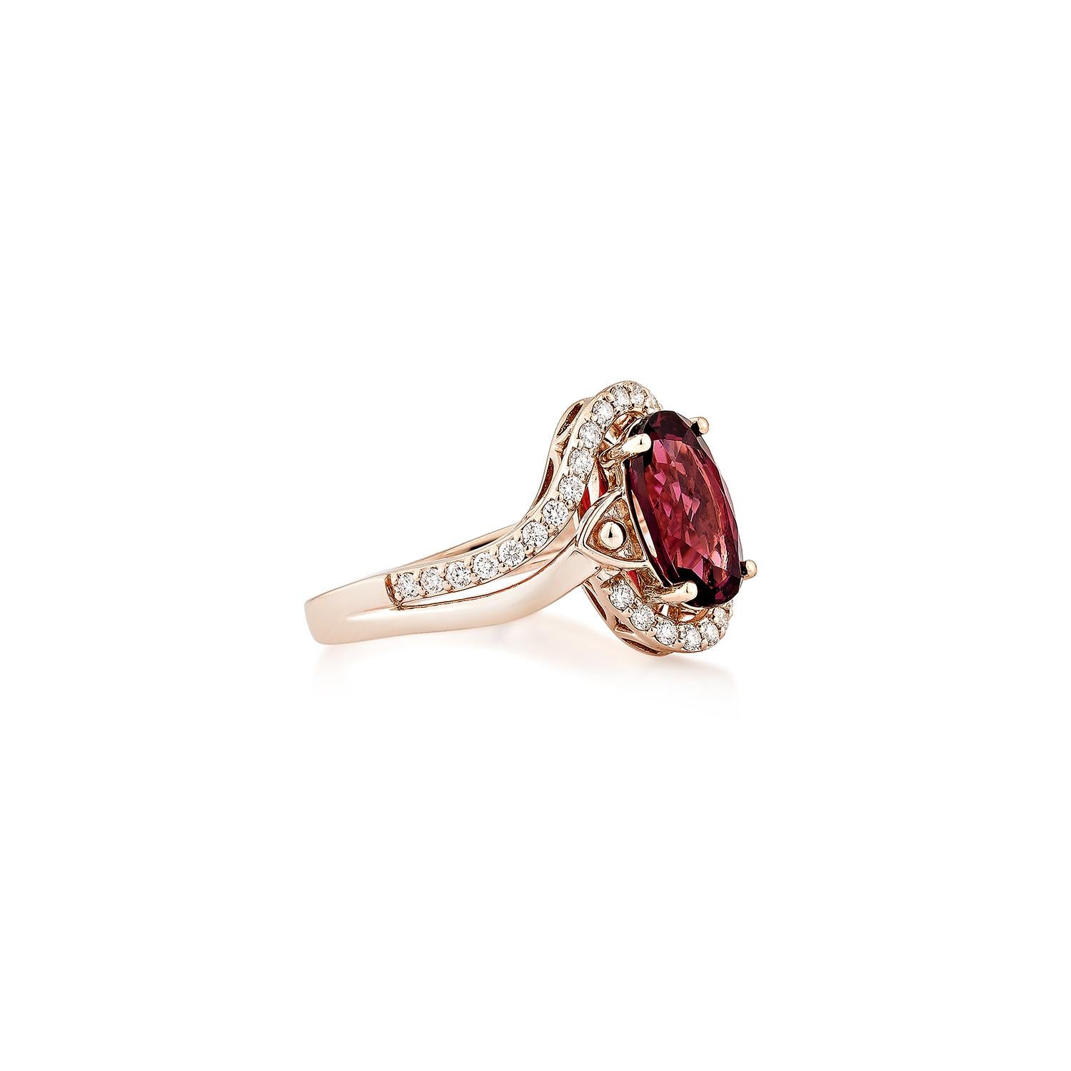 Sunita Nahata showcases an elegant Rhodolite fancy ring in an oval shape, adorned with sparkling white diamonds. This exquisite piece exudes grace and elegance, making it perfect for both daily wear and special occasions. Crafted from 14-karat rose