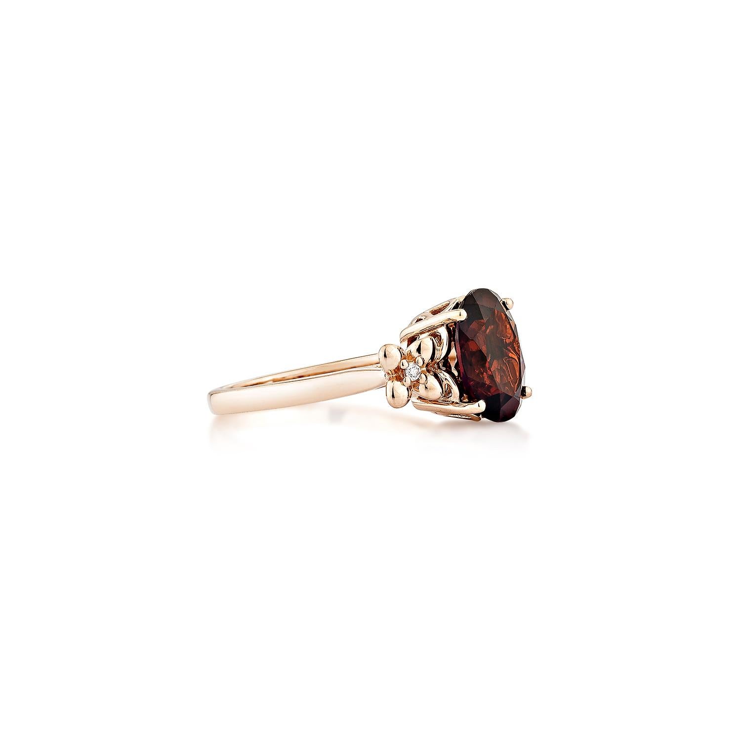 Presented A Fancy Ring of Red Garnet is perfect for people who want to wear it to any occasion or celebration. Its captivating garnet, and white diamond set in 14karat rose gold, intended to charm hearts and elevate any special occasion.
  
Red