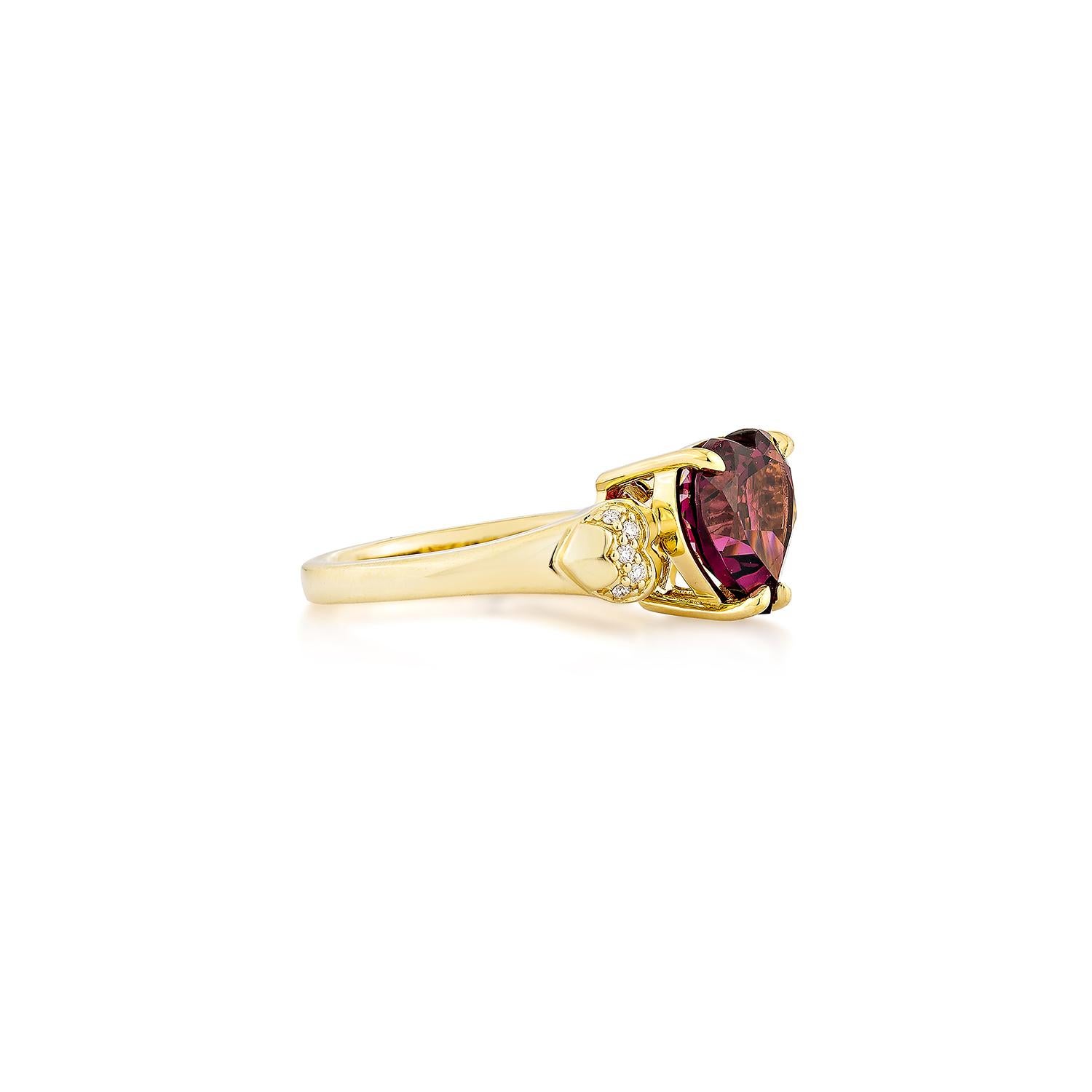 Sunita Nahata presents an elegant Rhodolite fancy ring in a heart shape, set with sparkling white diamonds. This exquisite piece exudes grace and elegance, making it perfect for both daily wear and special occasions. Crafted from 18-karat yellow