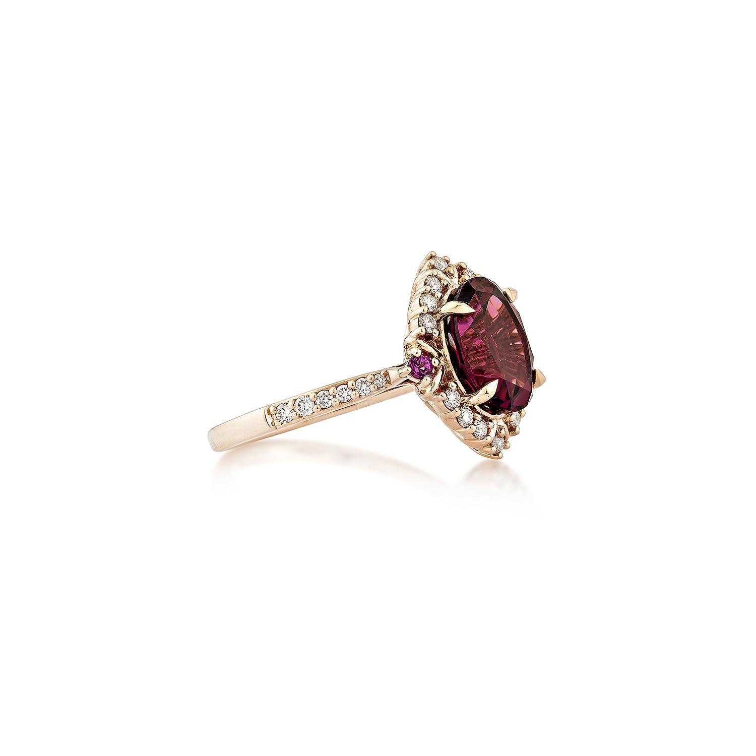 Sunita Nahata presents an elegant Rhodolite fancy ring in an oval shape, set with sparkling white diamonds. This exquisite piece exudes grace and elegance, making it perfect for both daily wear and special occasions. Crafted from 14-karat rose gold,