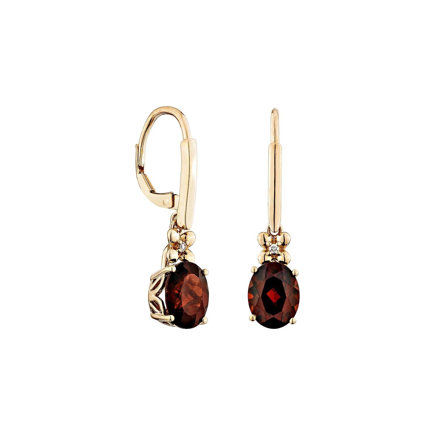 Elegant and timeless, these stunning drop earrings feature rich oval-shaped garnets, their deep crimson hues exuding a classic charm. Each garnet is delicately set in 14K rose gold, enhanced by sparkling white diamonds that add a touch of