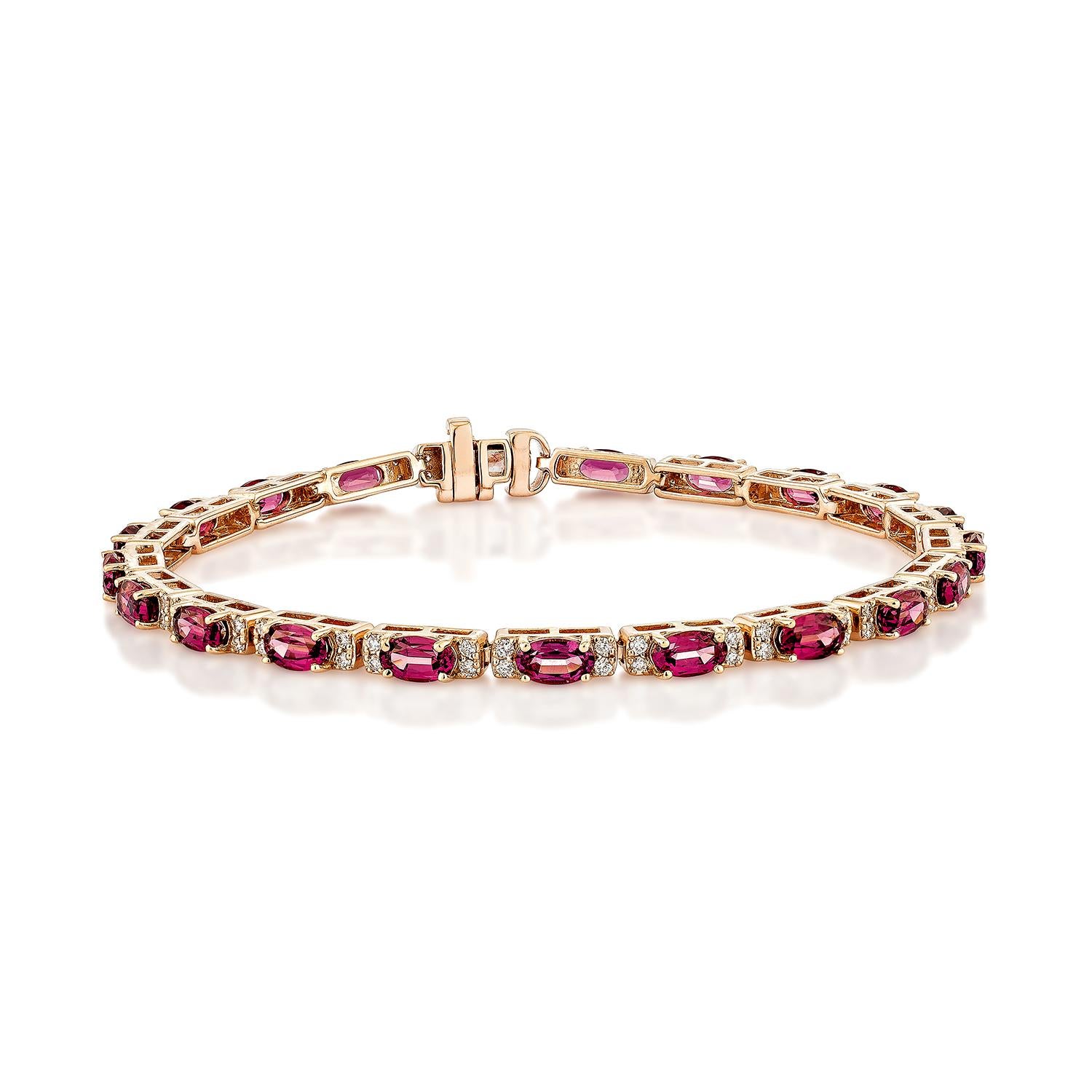 Elegant and vibrant, this 14K rose gold bracelet showcases a striking oval step-cut rhodolite at its center. The deep, rich hues of the gemstone are beautifully complemented by a delicate row of sparkling white diamonds, adding a touch of timeless