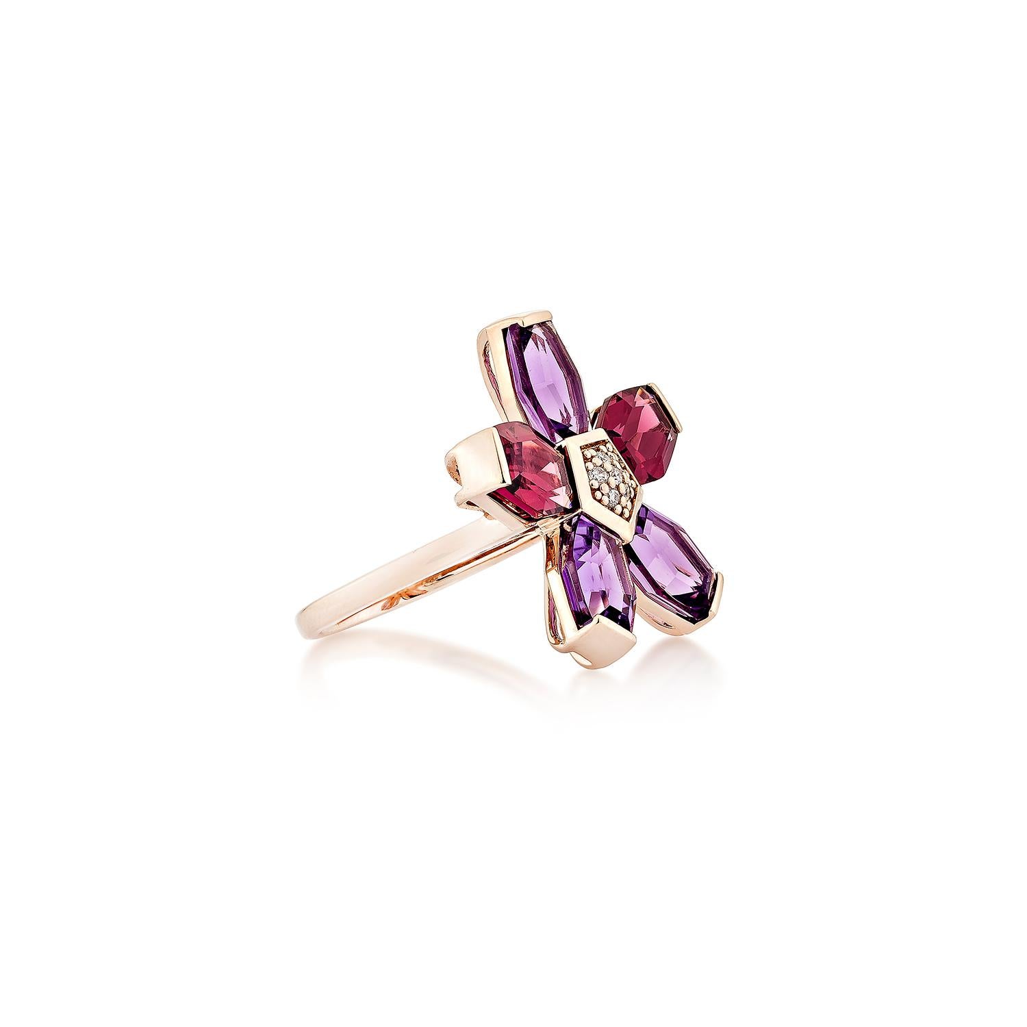 A mesmerizing floral-inspired cocktail ring, this exquisite piece features a captivating arrangement of faceted amethyst and rhodolite garnet gemstones, meticulously set in 14K rose gold. The vibrant petals radiate in rich purple and deep magenta