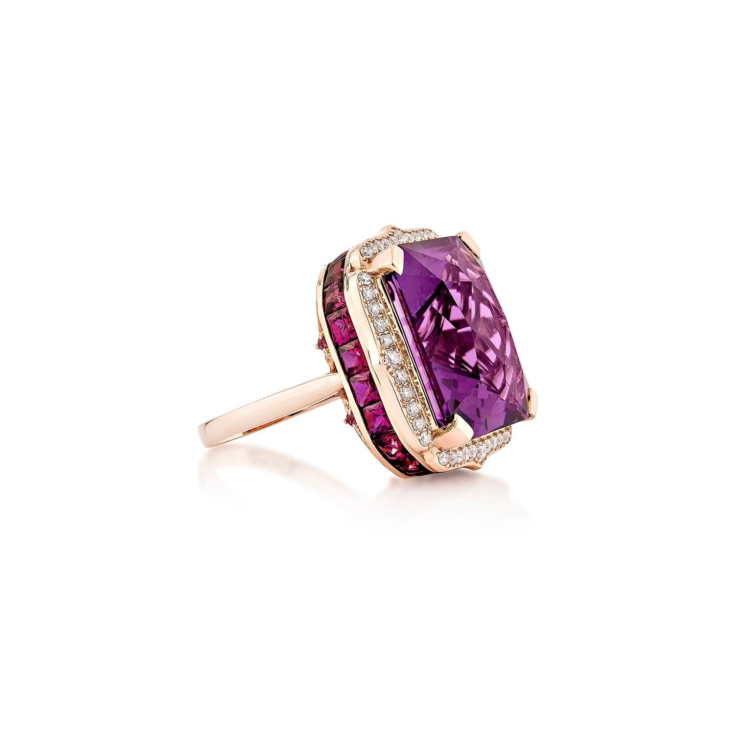 A striking square-cut amethyst sits at the heart of this bold cocktail ring, showcasing vivid purple brilliance with exceptional faceting. The center stone is framed by a halo of sparkling white diamonds and accented with a channel of deep rhodolite