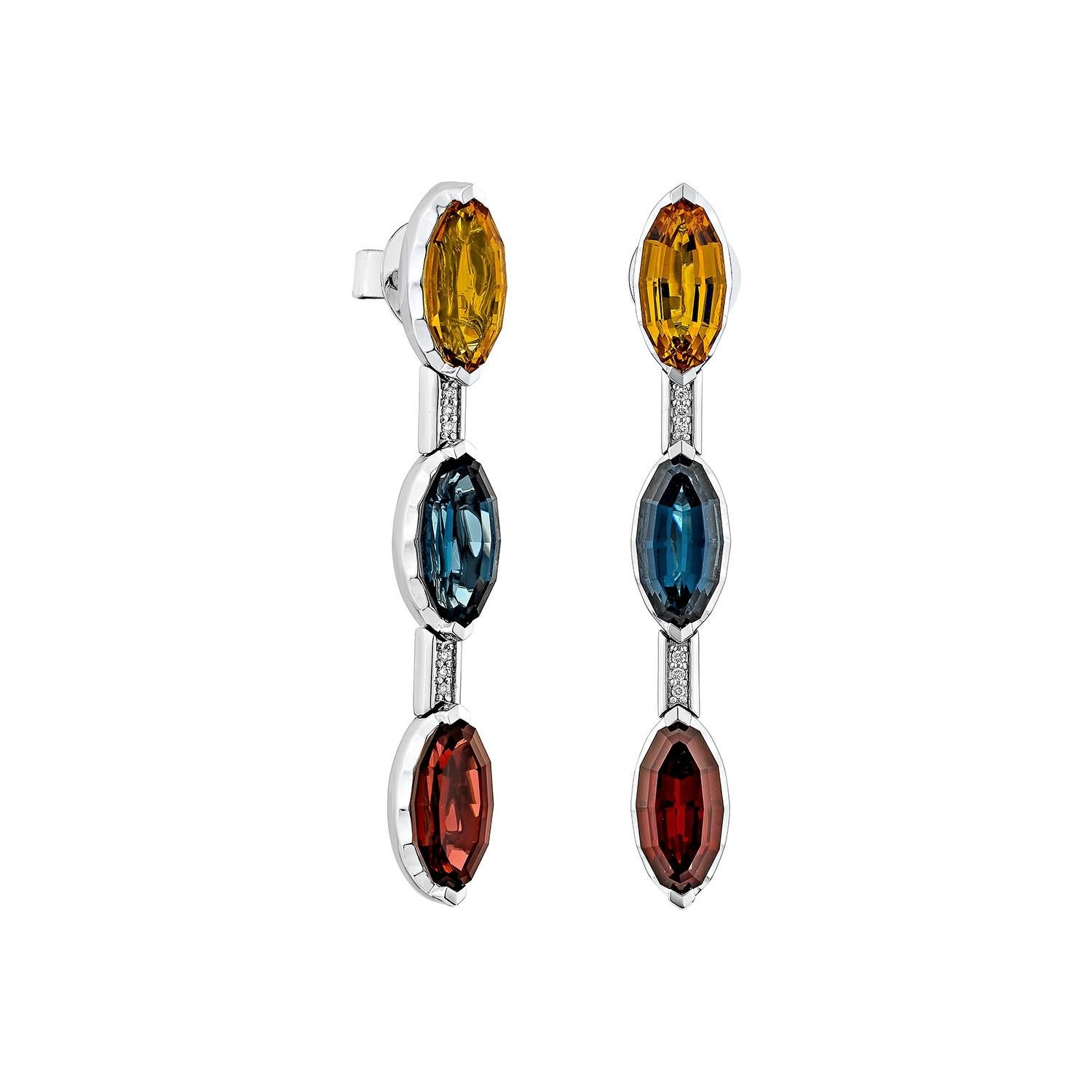 Elegantes pendientes colgantes de oro blanco de 14 quilates con un llamativo trío de citrino, topacio azul y granate de talla fantasía, acentuados con delicados conectores de diamantes. Un diseño elegante y moderno que exhibe un color atrevido y una