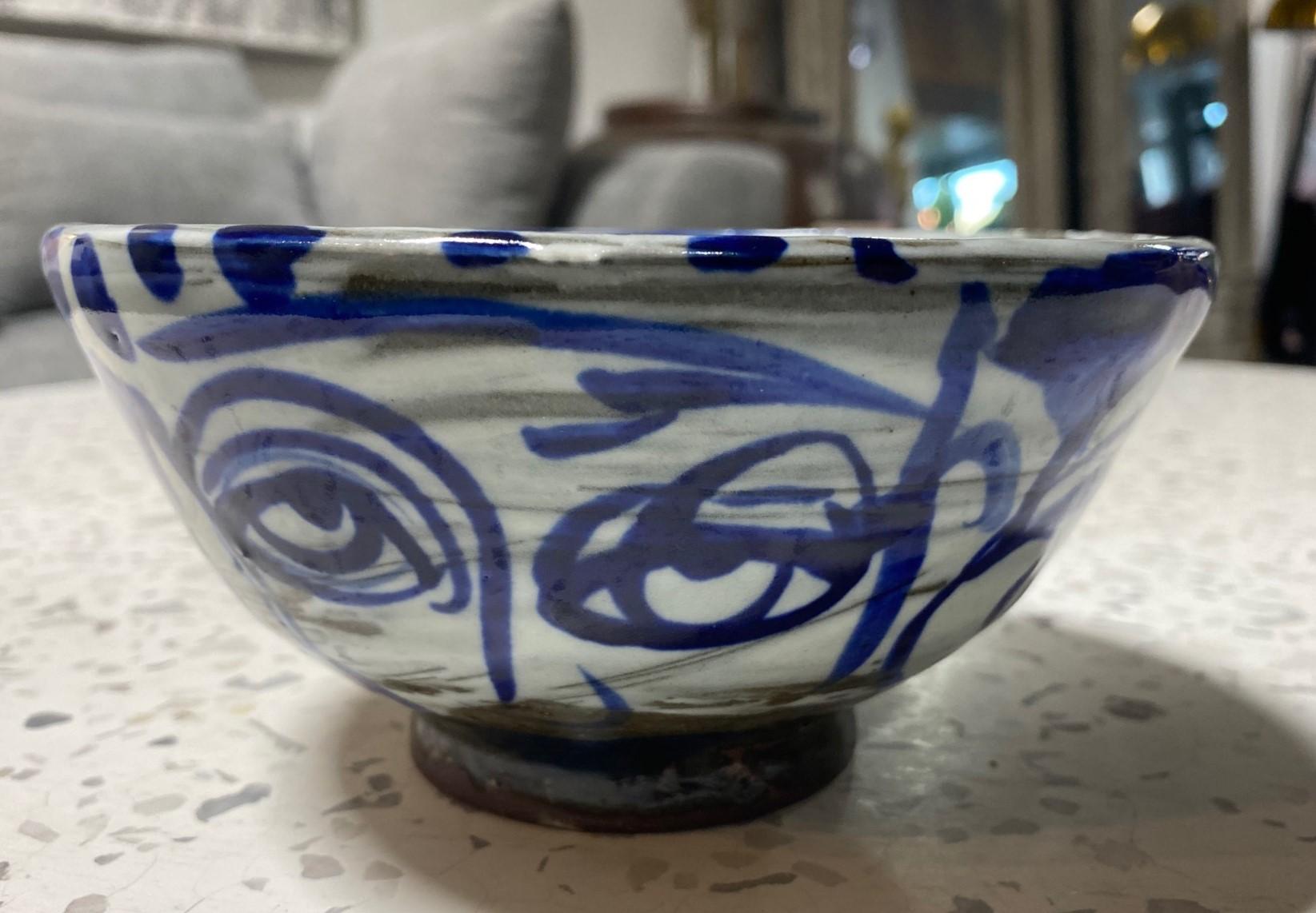 A wonderfully, hand-painted, one-of-a-kind studio pottery bowl by Korean-American master potter/artist Sunkoo (Sun Koo) Yuh. Yuh's work is often inspired by Buddhist and Confucian beliefs incorporated with socio-political messages. 

Yuh was born
