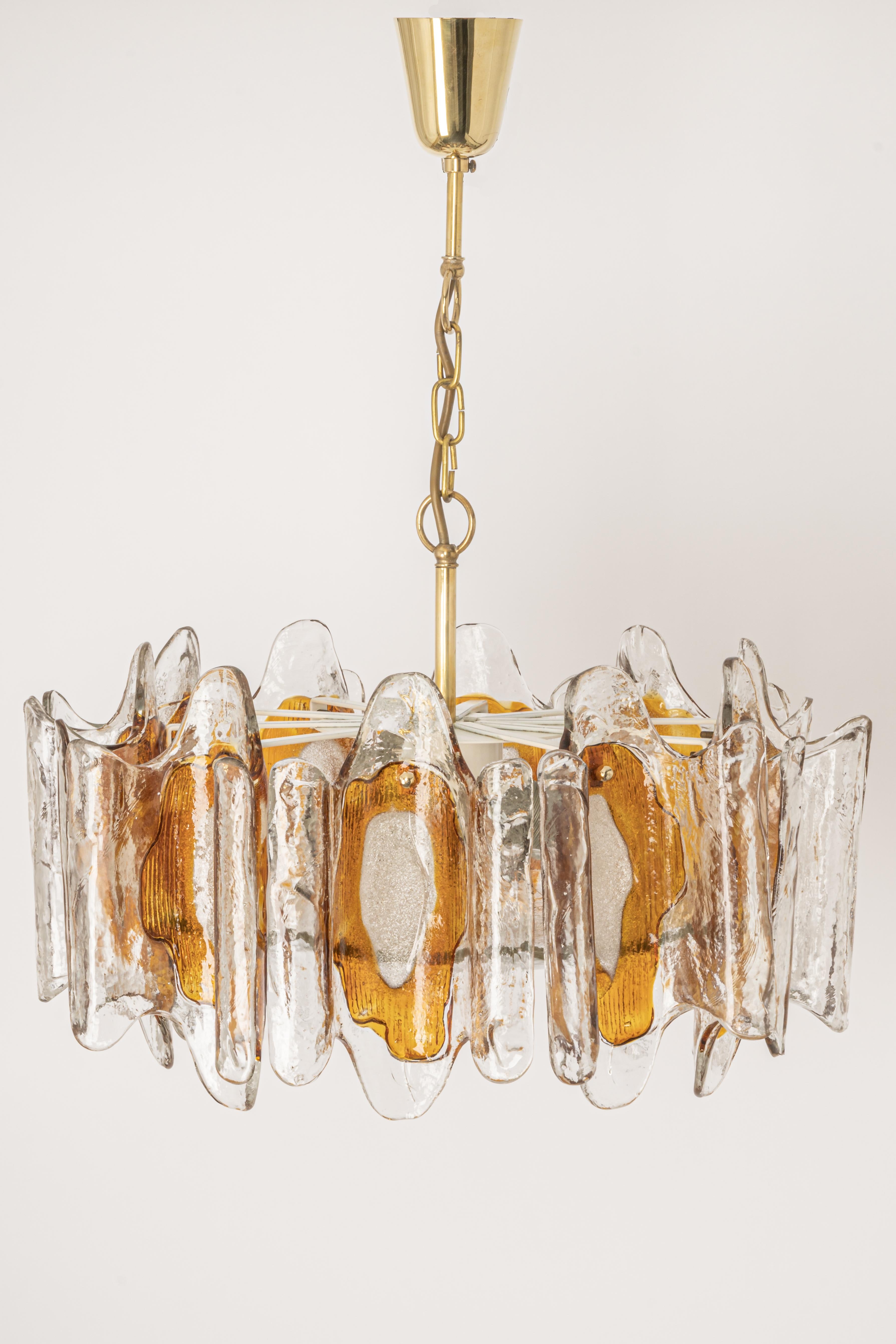 Impressive chandelier made of melted Murano glasses by Kalmar from the 1970s. This chandelier is absolutely timeless because of its simple and modern design.
Heavy quality and in very good condition. Cleaned, well-wired, and ready to use. 

The