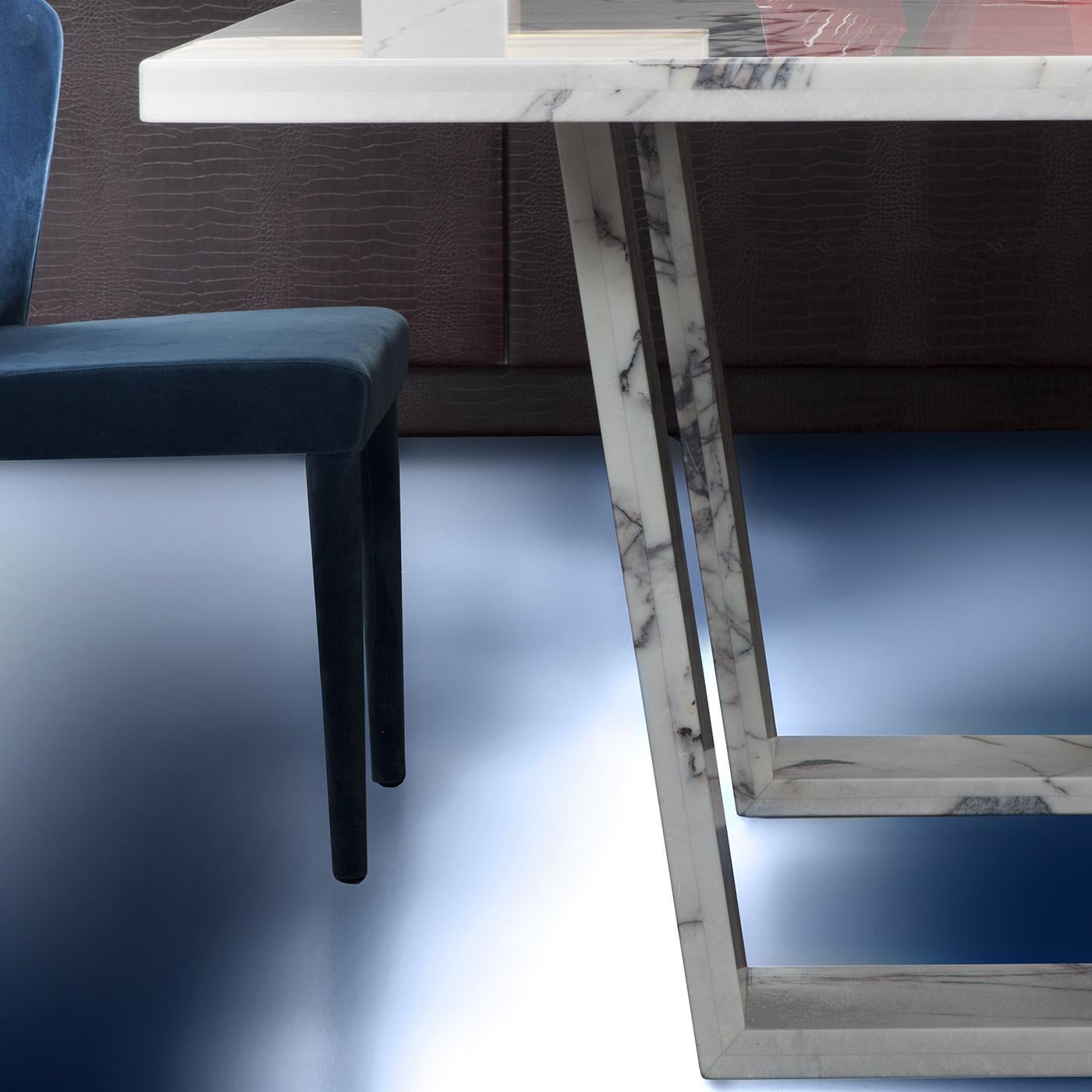 Designed by Giorgio Soressi, the sunny dining table is crafted in gorgeous Bianco Lilla Marble. A linear design, the rectangular surface sits on an elegant double base, lending a contemporary edge to the timeless style. Thanks to a protective