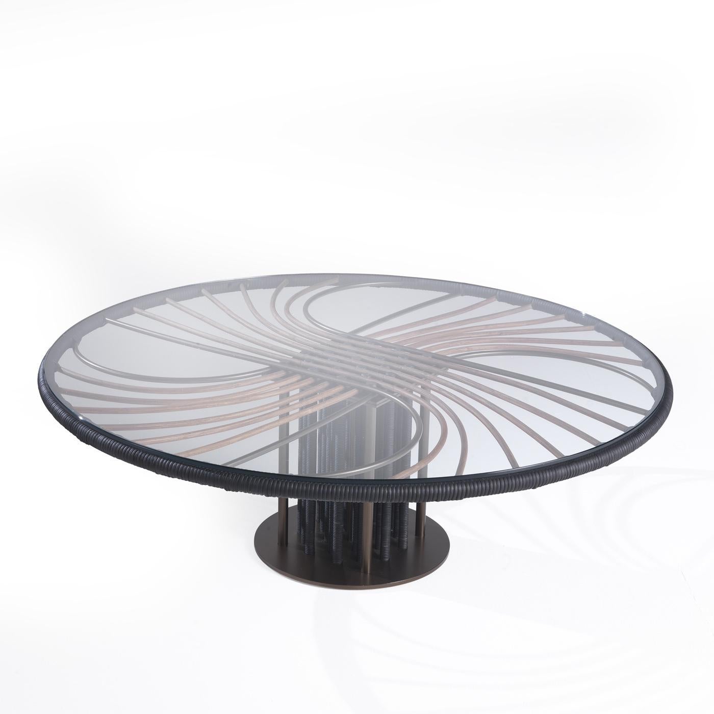 A superb example of impeccable craftsmanship, this coffee table will elevate any residential or office decor with refined sophistication. Resting on a circular base, the central support is composed of bronzed metal legs in different hues that hold a