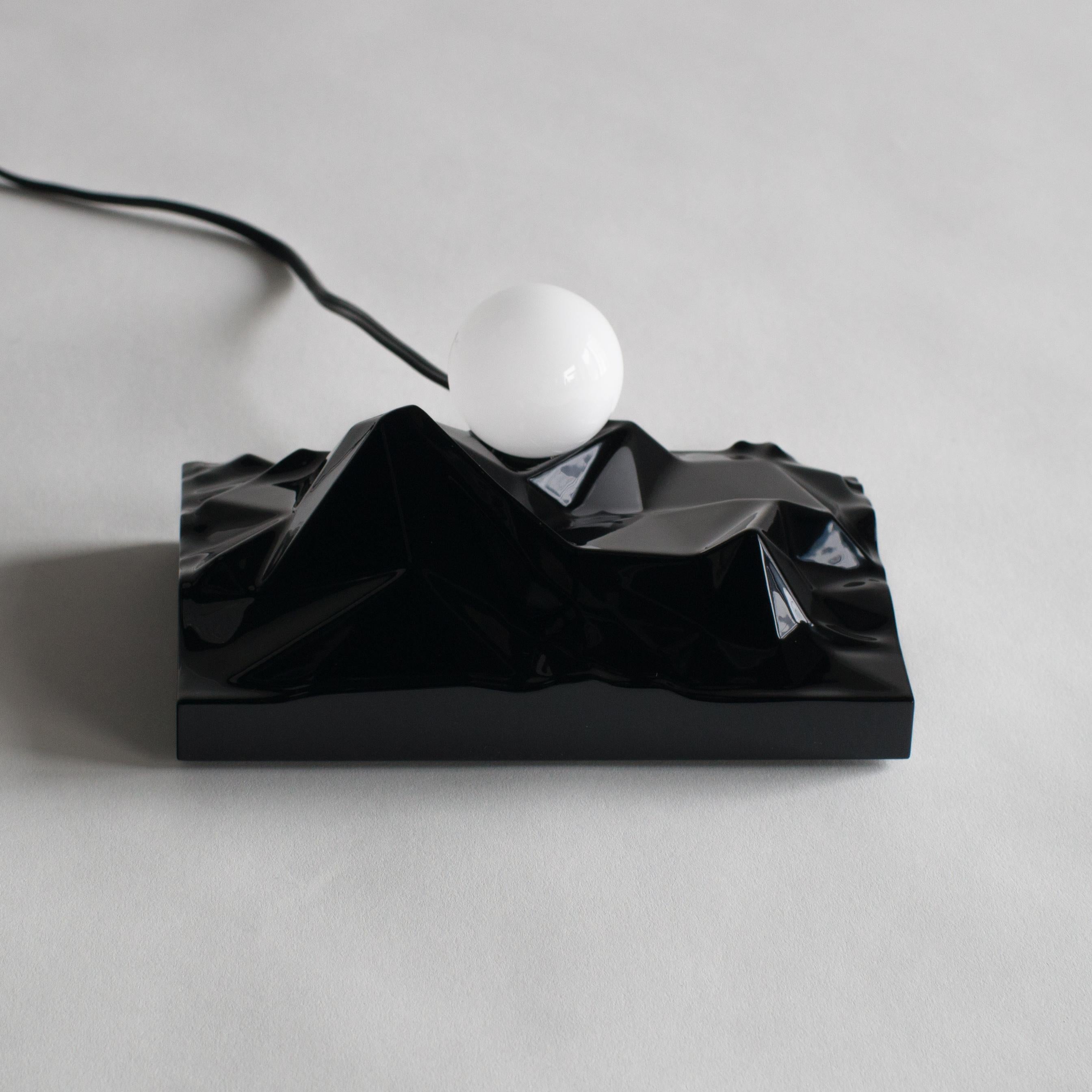 Table lamp designed by Satoshi Itasaka.
This work is made of Urushi lacquered base and light bulb. Base is shaped looks like mountains, light bulb compares to sun.


 