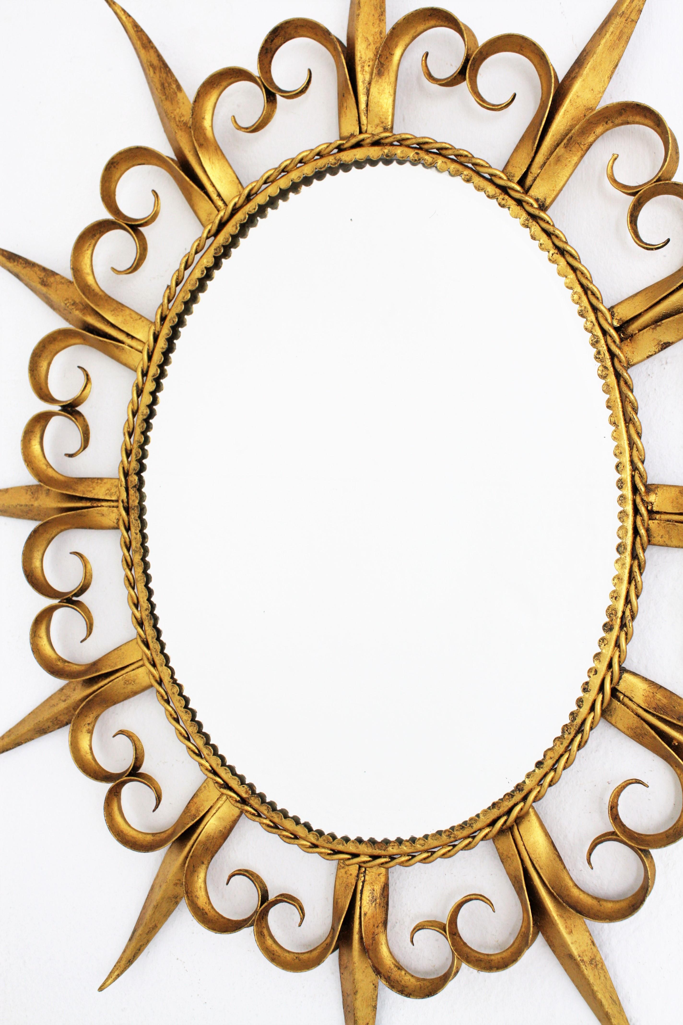 Mid-Century Modern Sunburst Eyelash Oval Mirror in Gilt Wrought Iron For Sale