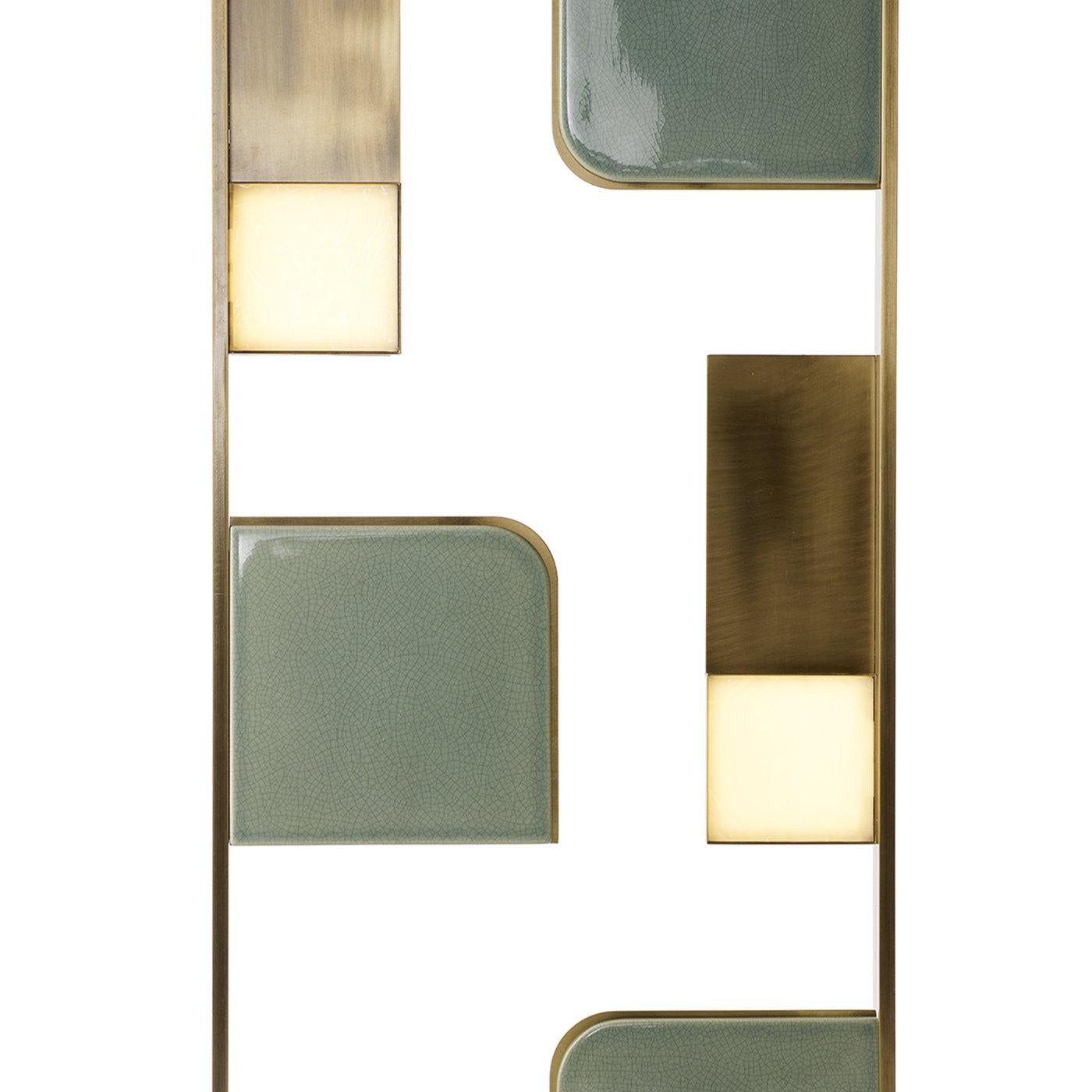This jewel-like floor lamp is an exercise in elegant craftsmanship and modern design. Introduced at Milan Design Week 2018, its structure is entirely made of brass with a brushed finish and comprises a base supporting a rectangular silhouette that