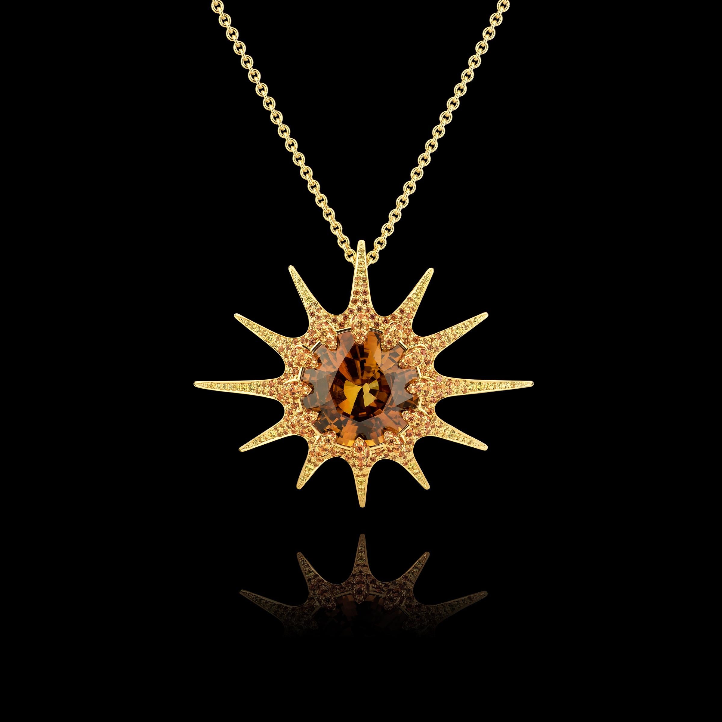 Sunset pendant from our Starlight collection.
-Natural zircon round mixed cut 27,48ct.
-309 hand set sapphires ca 3ct .
-handmade from 18K yellow gold.
-chain is not included in the price.

 The Sunrise tells an array of encapsulating stories but to