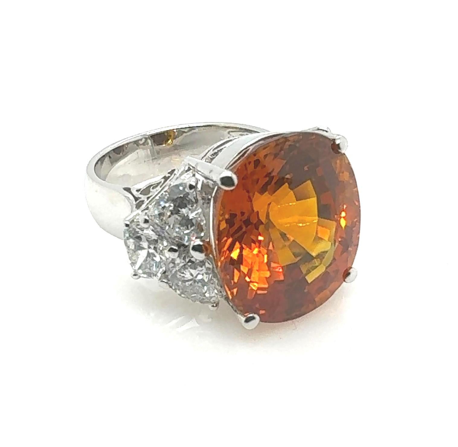 Gemstone
Certified Orange Sapphire: 19.95 Carat
Diamond:  2.95 Carat
Metal: 18K White Gold
               Illuminate your collection with the Sunset Splendor Sapphire Ring, an embodiment of beauty, rarity, and unparalleled value. This exquisite