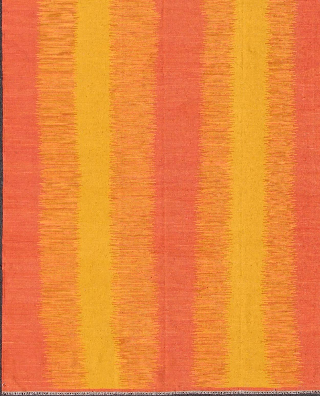 This gorgeously woven designer Kilim is decorated with a vertical stripe pattern. The flat-woven rug is rendered in shades of yellow, orange and pink; the composition is exceptionally reminiscent of a beautiful sunset.

Measures: 10'5'' x