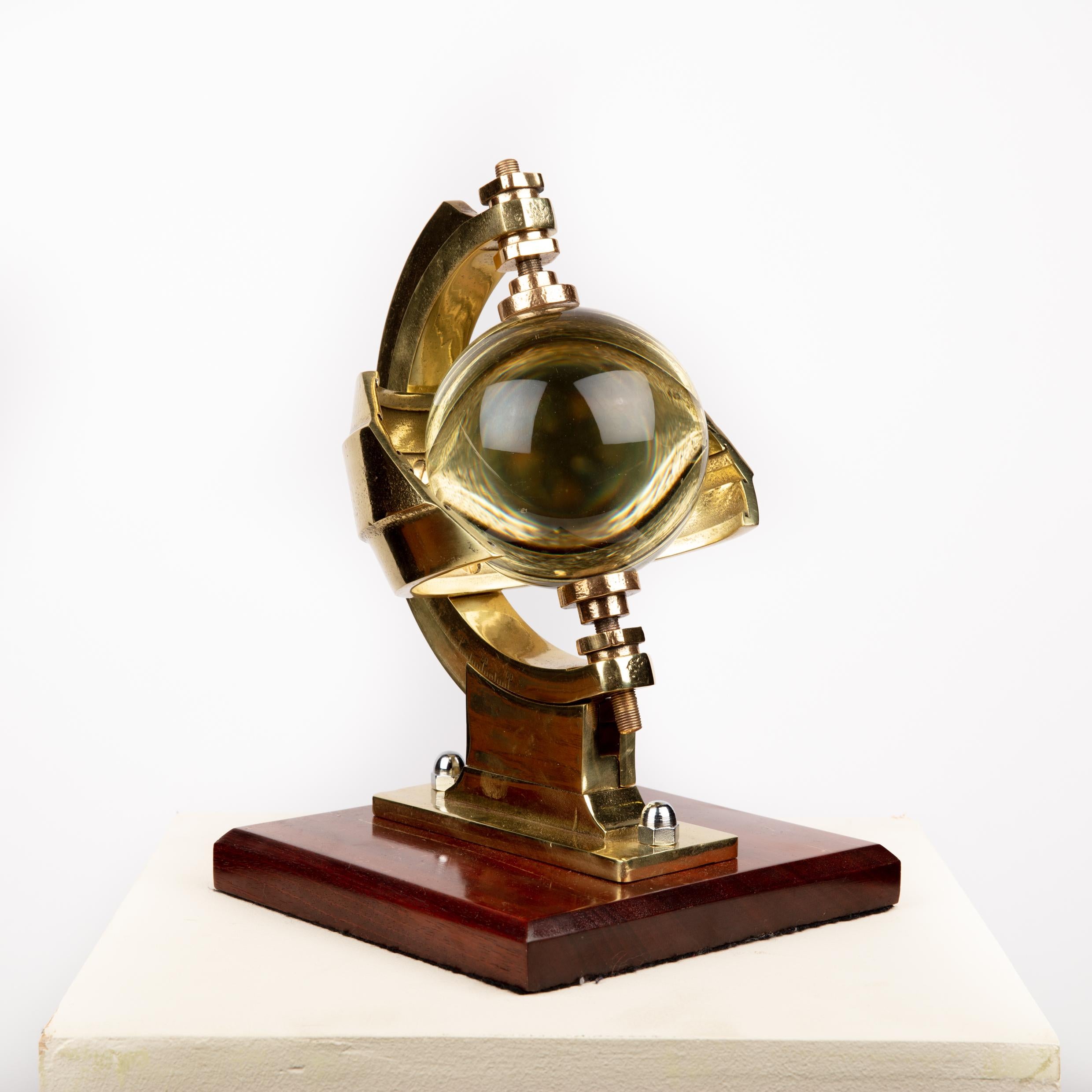 A Campbell–Stokes sunshine recorder, attributed to Casella & Co, circa 1910.
 
Mounted on a later wooden display plinth.

Marked with serial number to base: 1852.

The Campbell–Stokes sphere is used to record sunshine. It was invented by John