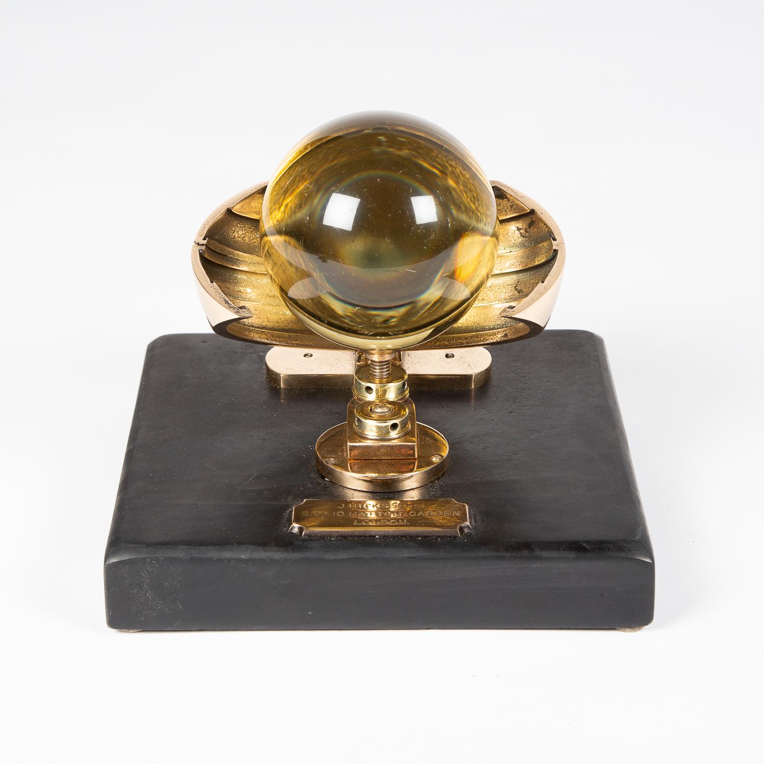 A Campbell–Stokes sunshine recorder, by J Hicks of Hatton Garden, London, circa 1900.

Mounted on a slate base with bronze plaque: J.HICKS. MAKER. 8. 9 & 10. HATTON GARDEN LONDON.

Improved Campbell–Stokes sunshine recorder with adjustable bowl