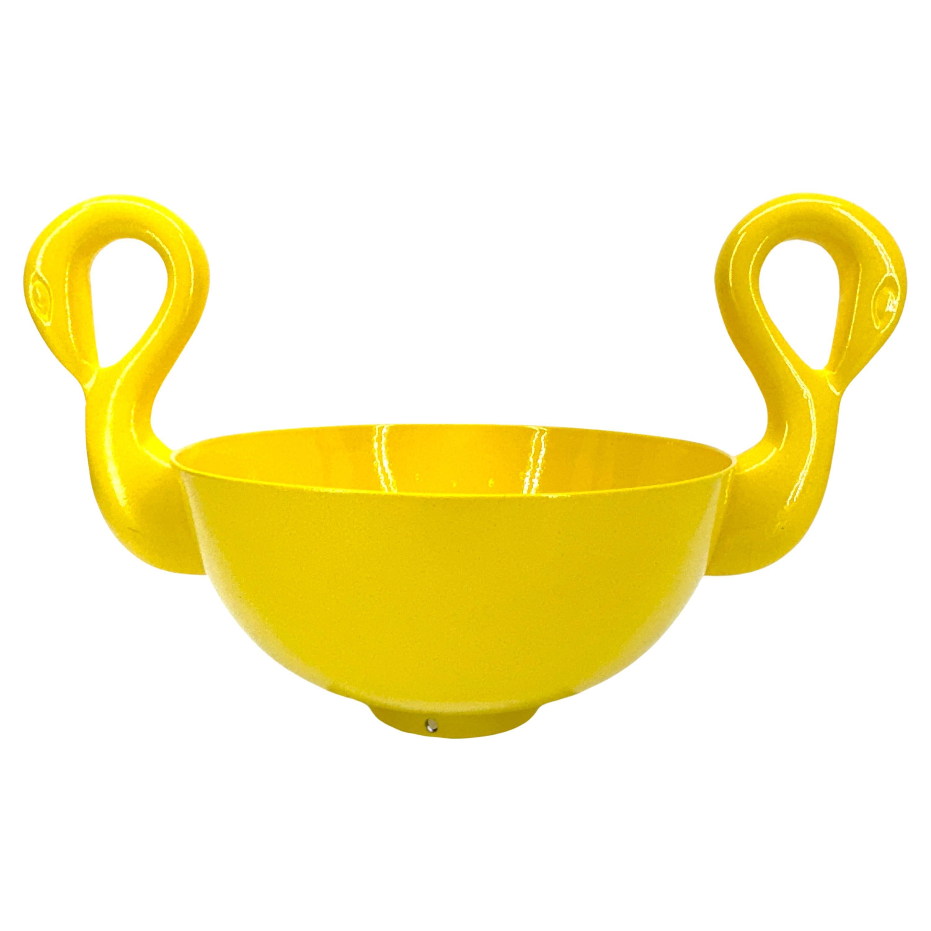 This is a unique English decorative bowl, functional as well as fun. There are many uses for this versatile freshly powder-coated bright sunshine yellow piece. This bowl features two swans that certainly would be a perfect statement piece on a side