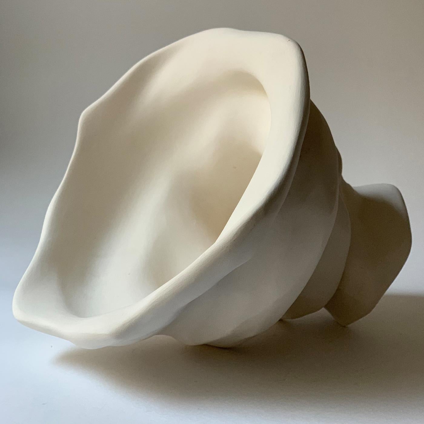 Recalling the spiraled interior of a shell, this exceptional sculpture is defined by a sinuous movement and a smooth and polished surface. Handmade of white clay, it is enhanced with a stunning play of chiaroscuro. This exquisite, one-of-a-kind