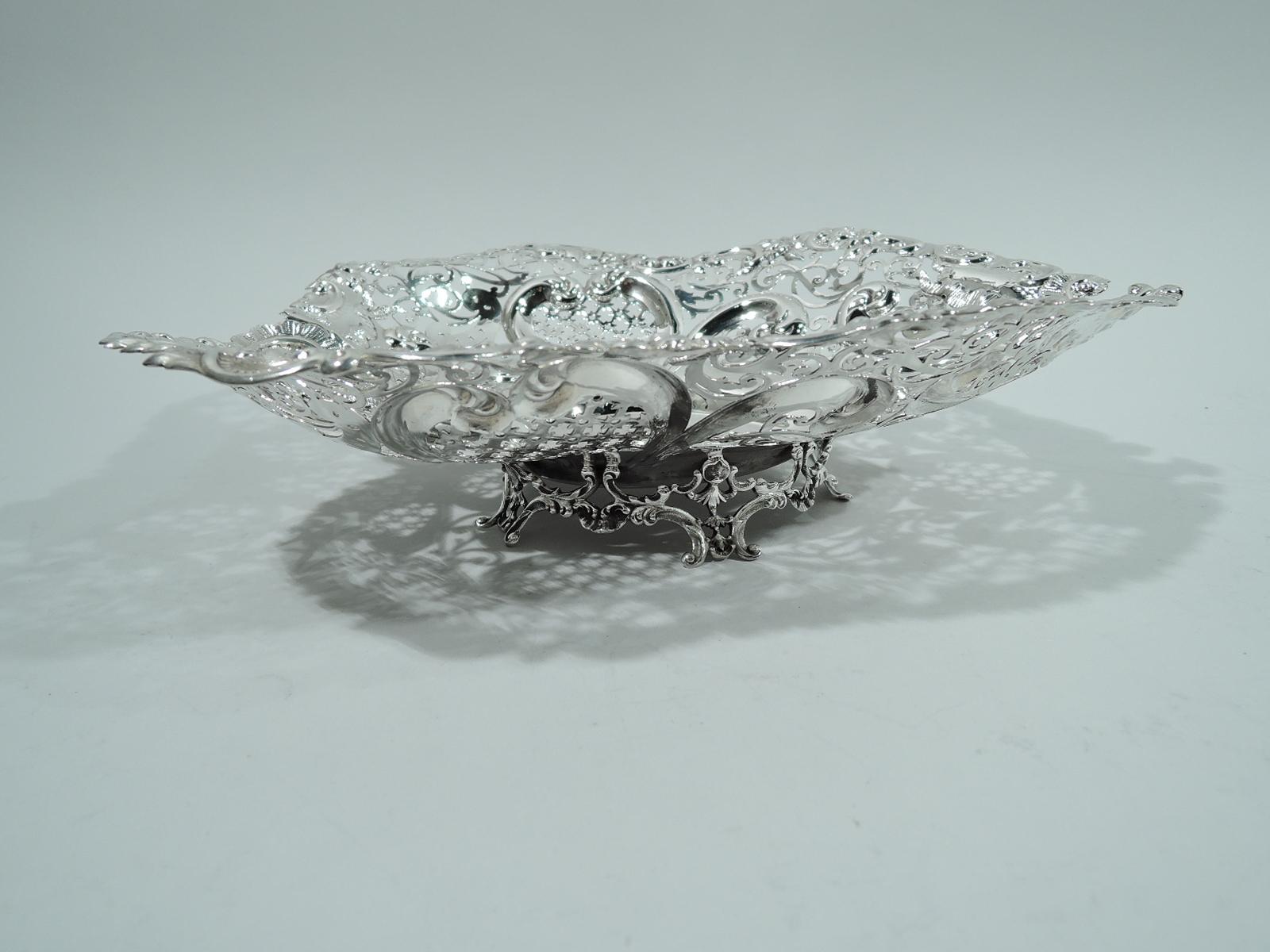 Super big and super romantic sterling silver heart bowl. Made by Gorham in Providence in 1910. Solid well; curved and tapering sides with chased scrolls and ribbon bows, and pierced geometric ornament. Irregular rim with scrolls, leaves, and