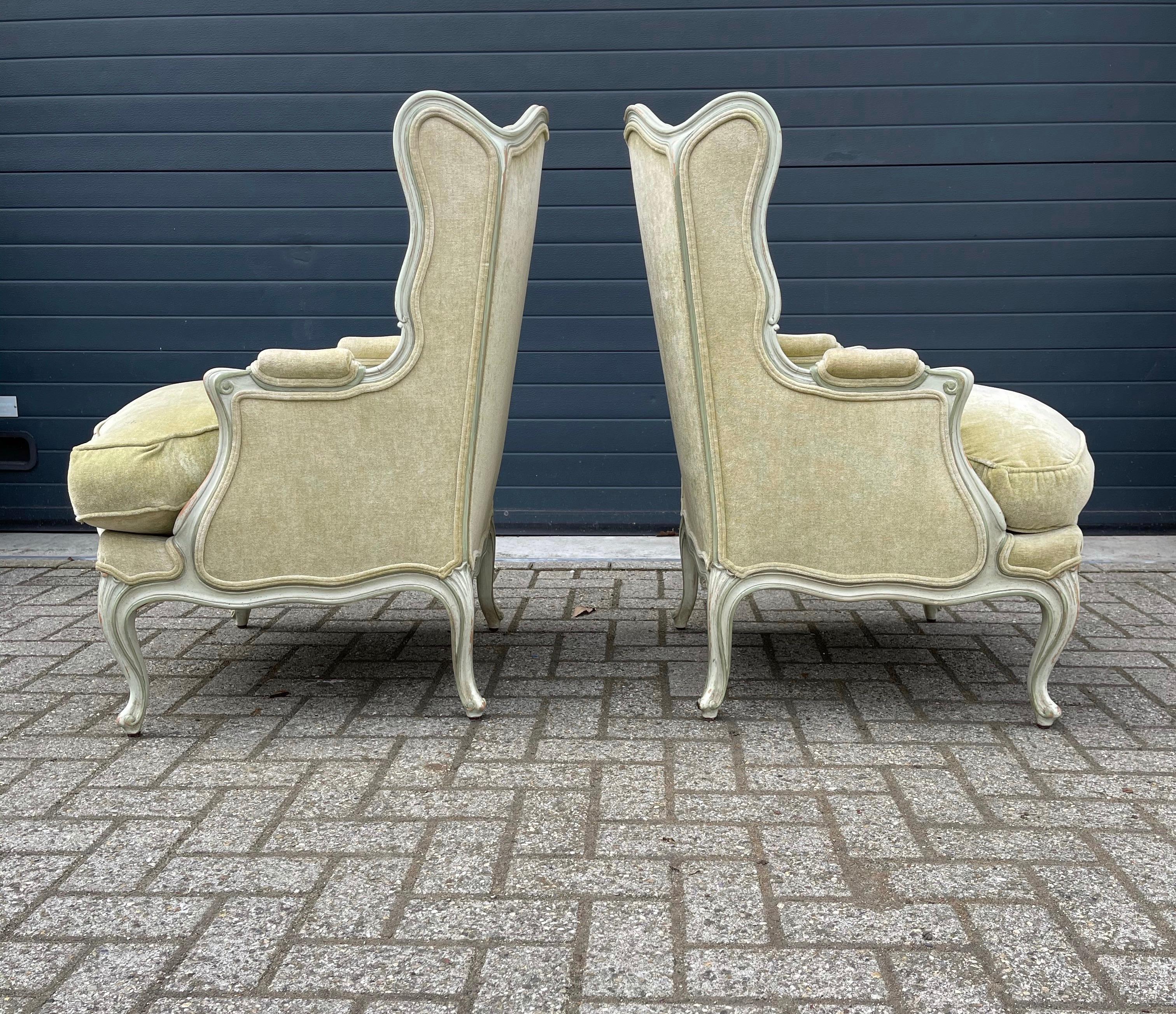 Magnificent design with classical green velvet upholstery wing back chairs.

This vintage and pastel green painted pair of wingback chairs is beautiful in design, they are in superb condition and very comfortable to sit it. This stylish and