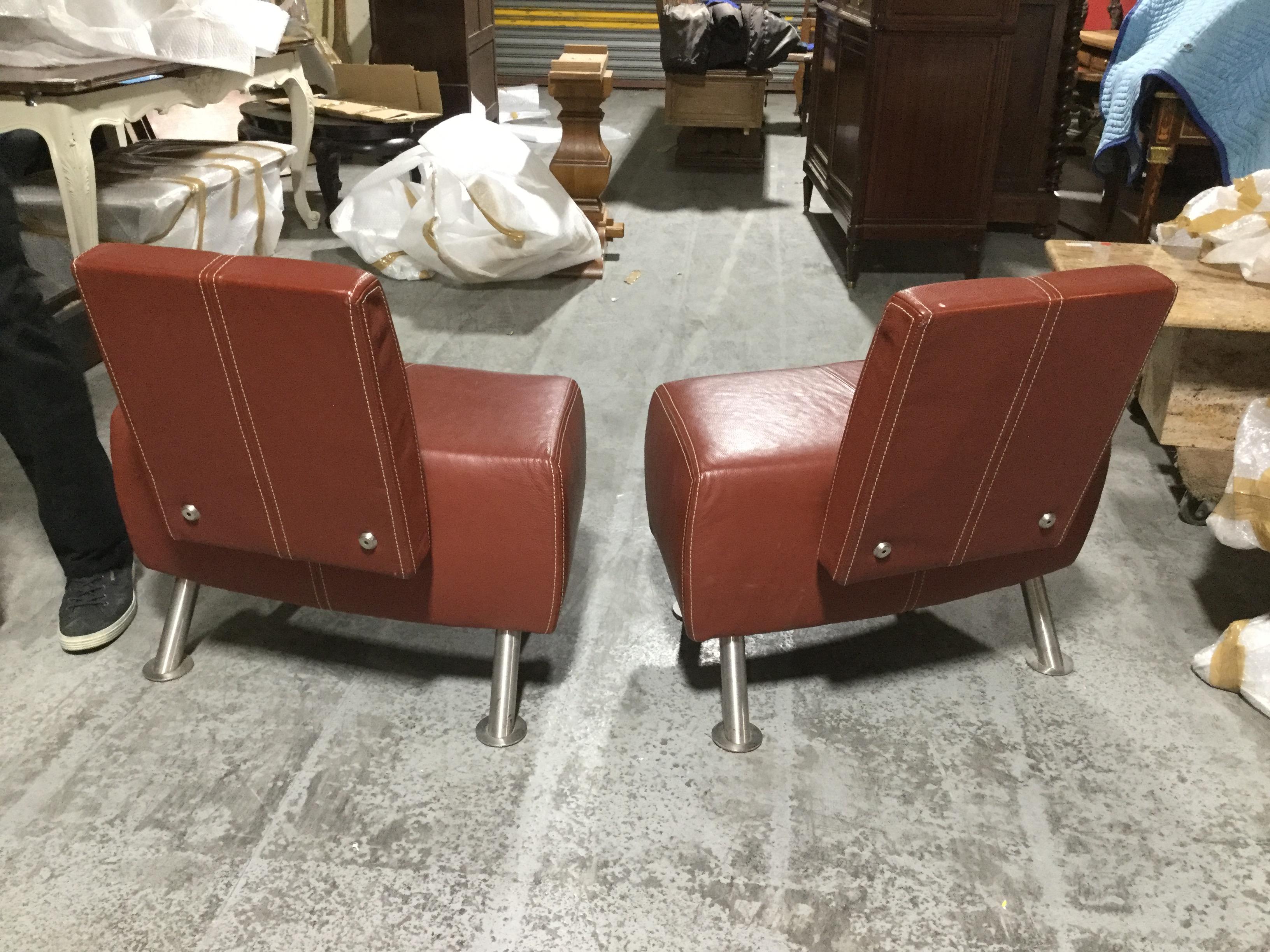 Contemporary high design Italian leather chairs in oxblood hide with top stitching and steel legs.

    