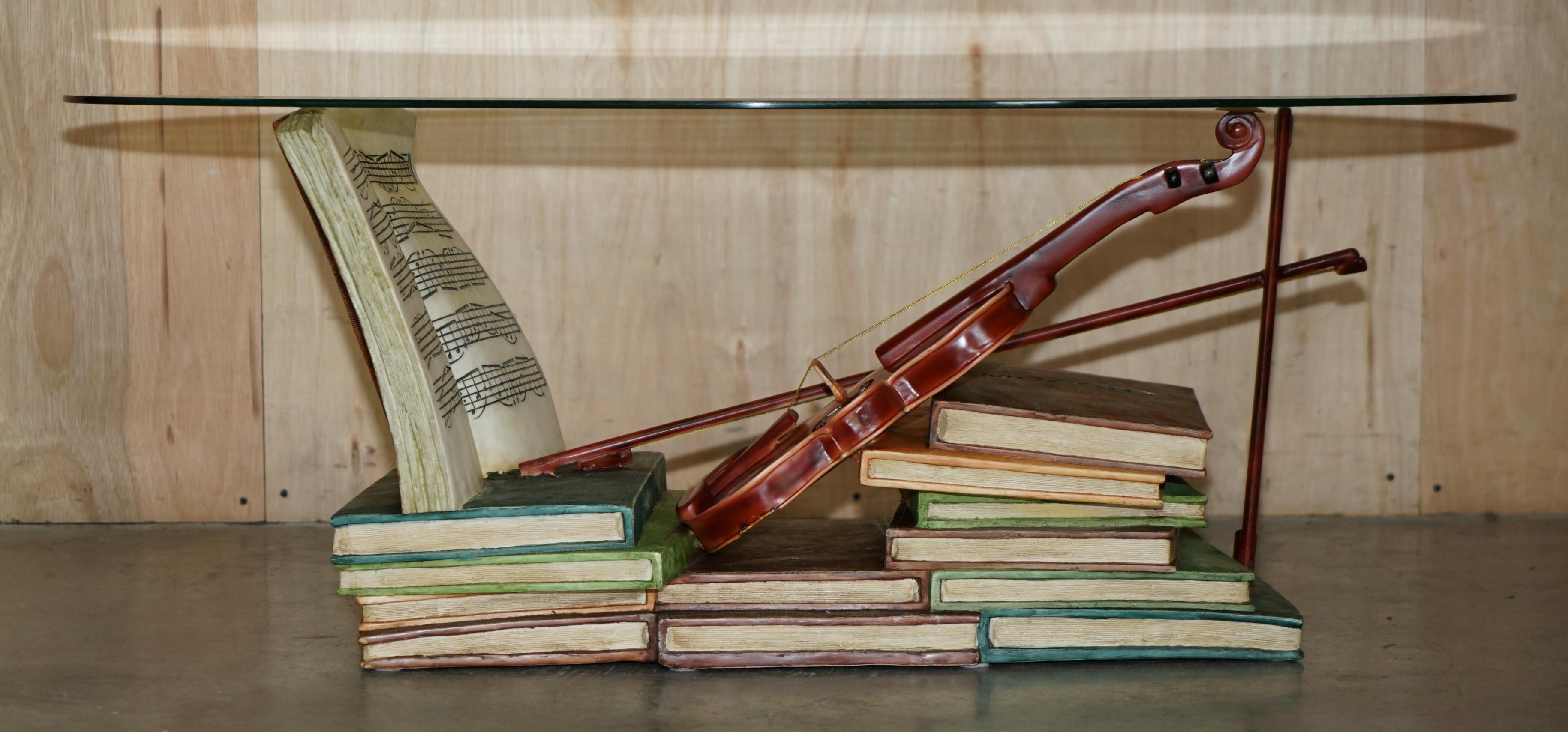 Royal House Antiques

Royal House Antiques is delighted to offer for sale this super decorative hand painted stack of books coffee table with a Violin depicting Mozart's study or music room and finished with an oval glass top 

Please note the