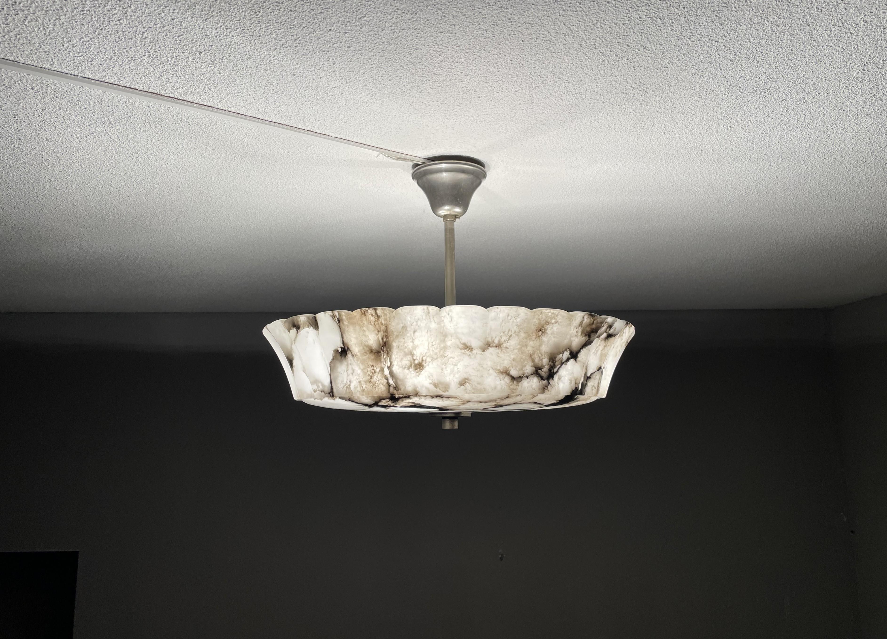 Rare and majestic, three light alabaster flush mount from the heydays of the Art Deco era.

This rare and large size Art Deco flush mount comes with a stunning design and a superbly polished alabaster shade. This almost flat at the bottom alabaster
