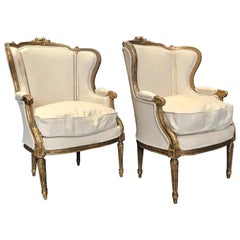 Super Dramatic Pair of Giltwood and Upholstered French Wingback Club Chairs