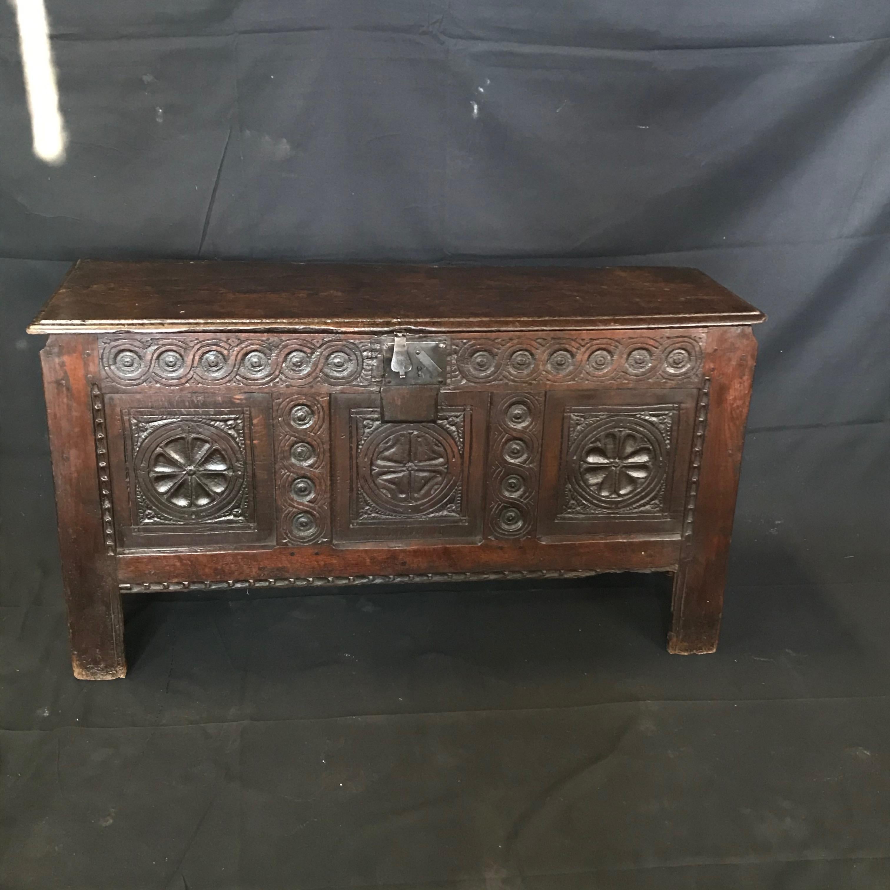 Exceptional early French coffer chest having a single plank top faced with a moulded edge and with a later iron hasp. The front has a beautifully carved gadrooned frieze above three panels separated by moulded uprights with punched decoration in the