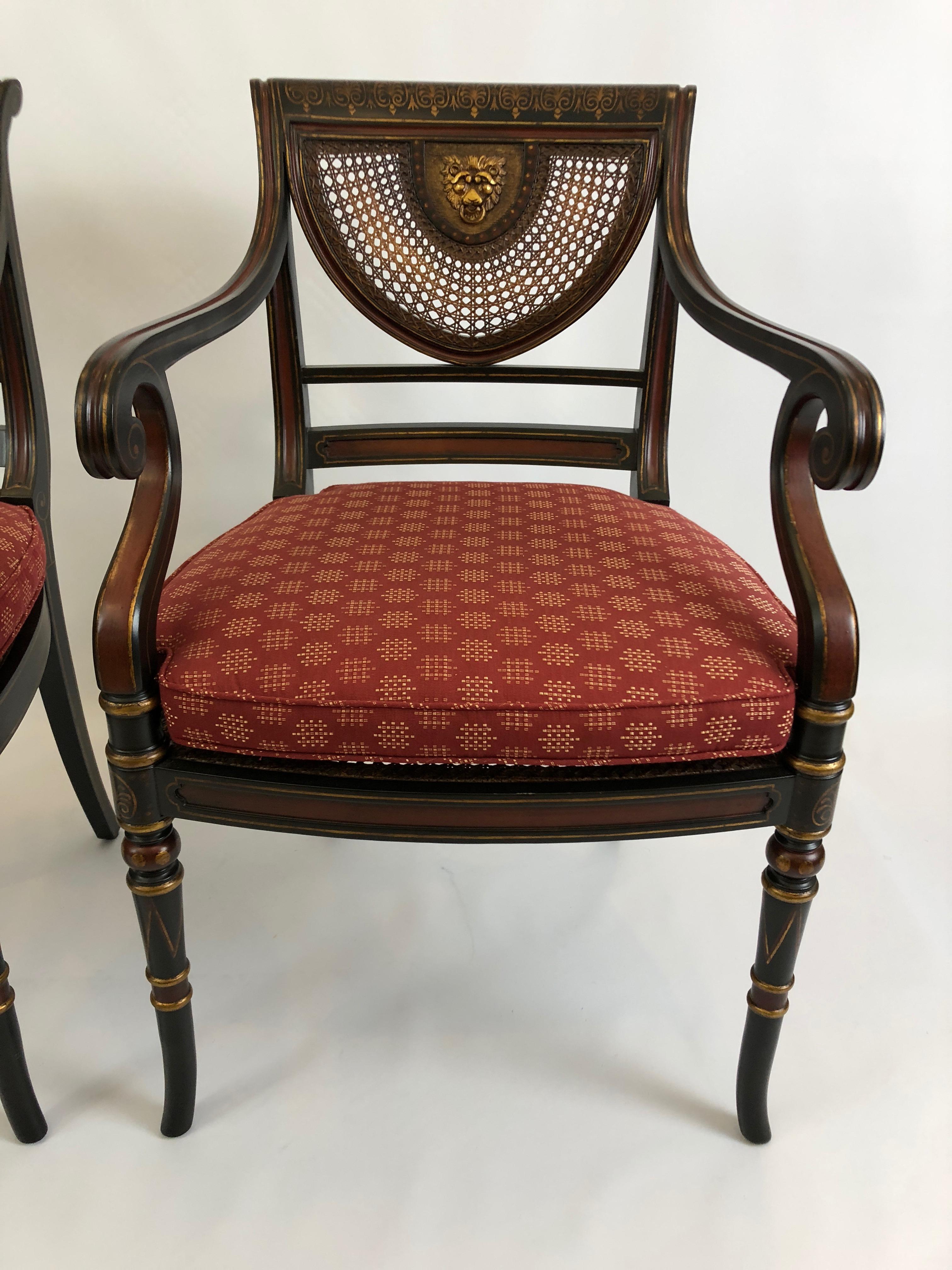 Beautifully designed elegant arm chairs having black, red and gold color palette with stunning caned half moon shapes on the backs that surround a gorgeous gilded lion's face. The seat is also caned, and comes with custom cushions.
Arm height 28