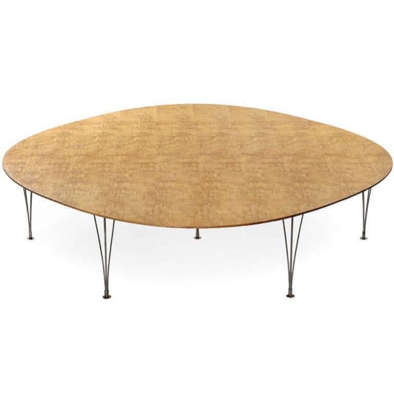 A rare 'Super Ellipse' conference or dining table with a top in figured birch burl and tapering chromed steel legs.