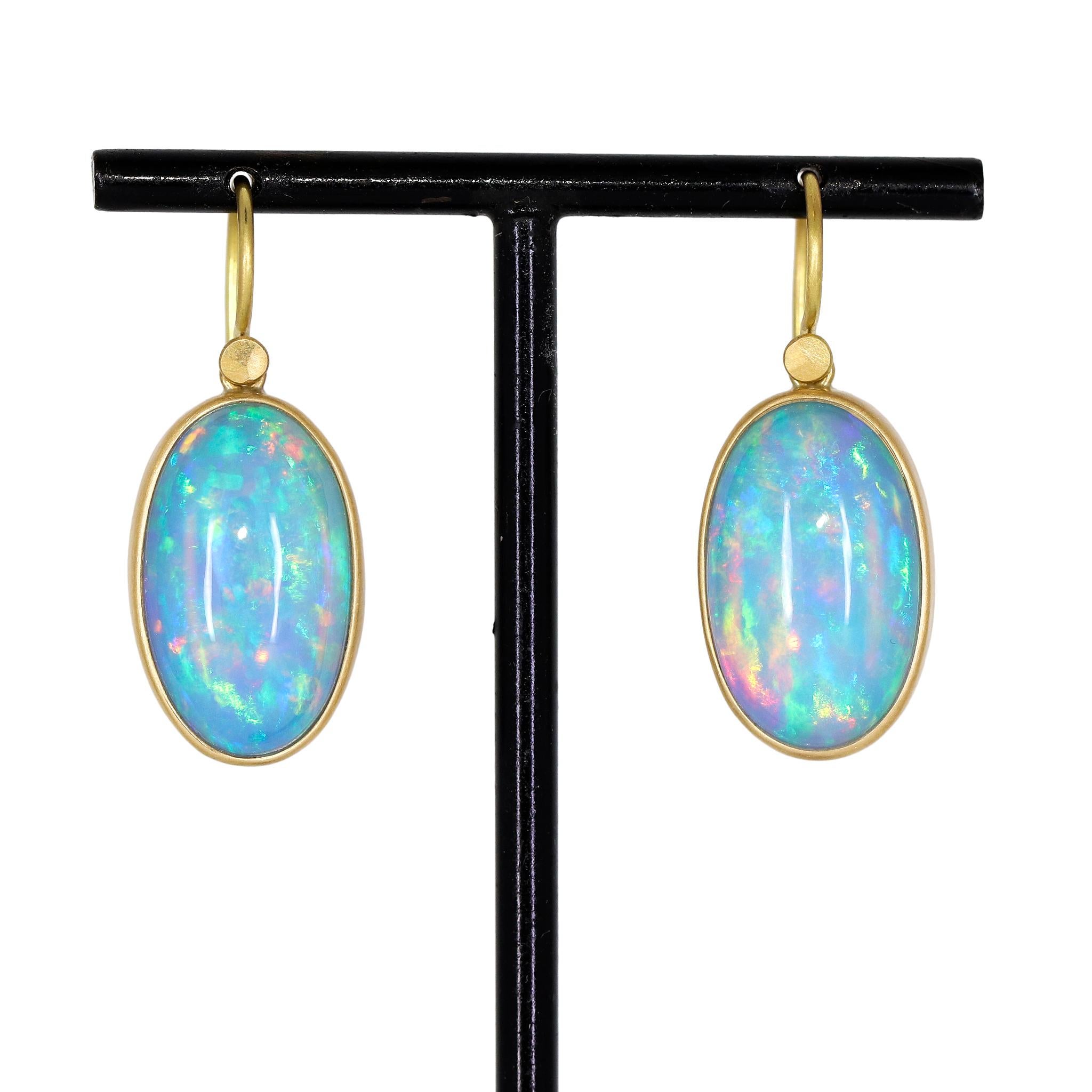 One of a Kind Earrings by jewelry maker Lola Brooks hand-fabricated in matte-finished 18k yellow gold featuring a truly phenomenal matched pair of oval Ethiopian opal cabochons totaling 13.85 carats cabochons set over blackened 18k gold emphasizing