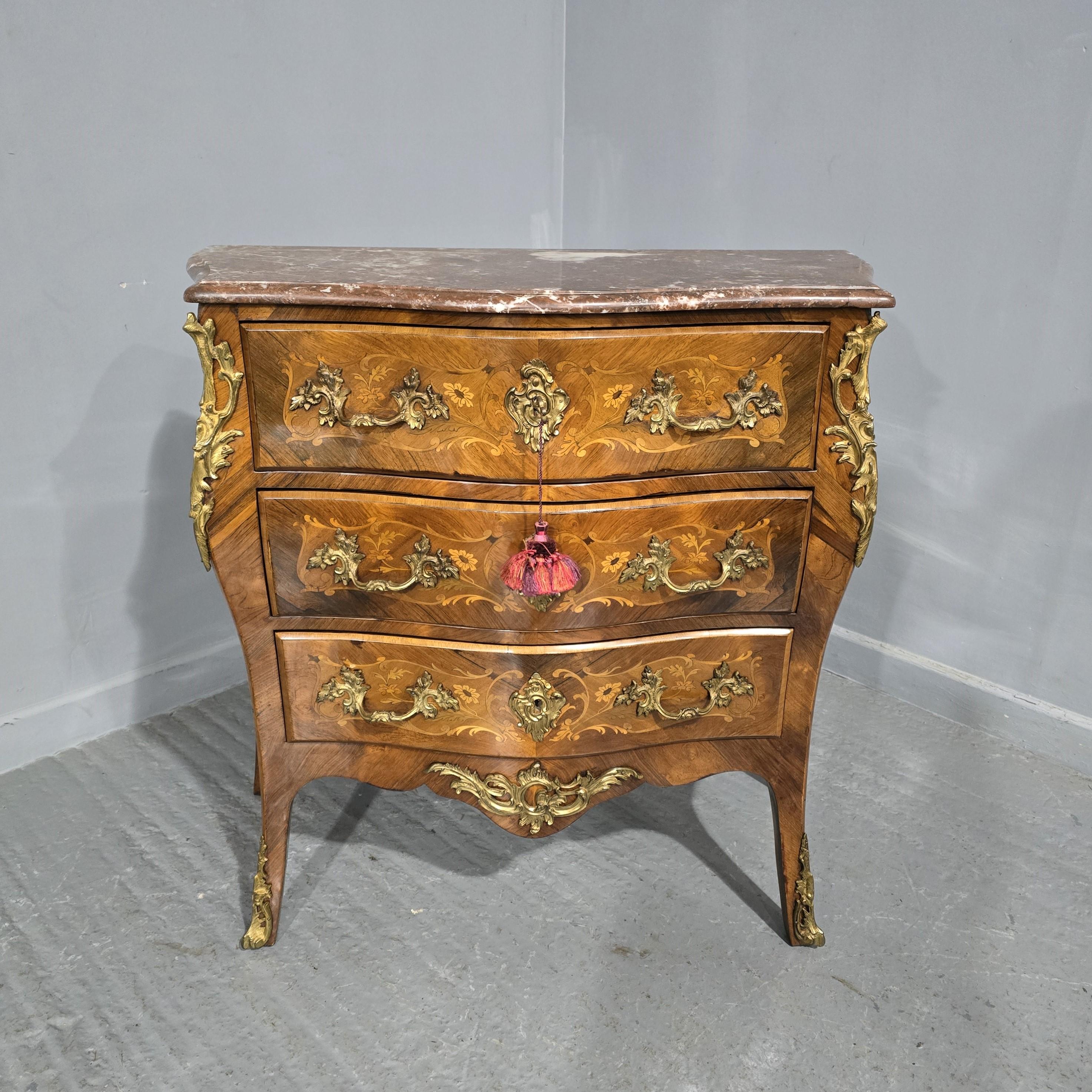 A wonderful small size French bombe  shaped commode chest of three drawers, marquetry panels to the sides and drawers fronts, ormolu mounts and handles, and a superb rouge marble. in excellent overall condition.

34.5