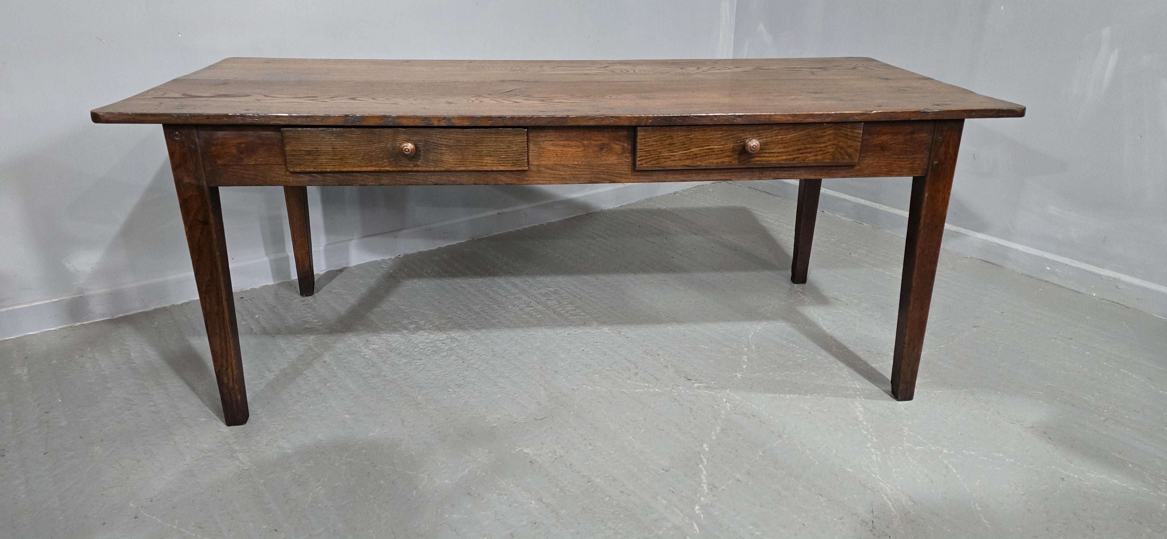Superb early C19th two plank French oak dining table, with two side drawers, peg jointed throughout, excellent colour and condition.

30.5