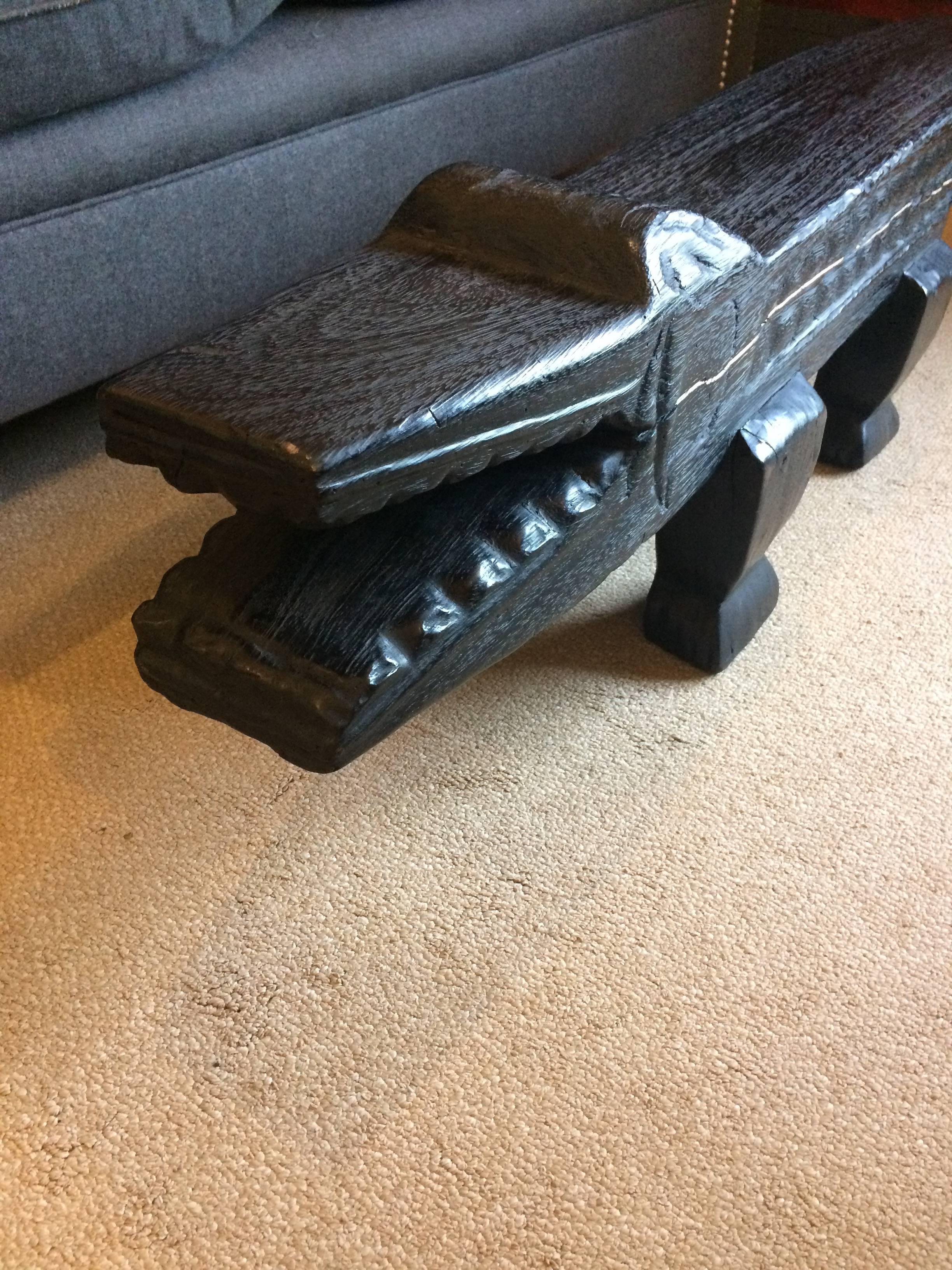 A super fun stylish low slung carved wood alligator, one of a kind, ebonized and abstract. Could be used as a narrow coffee table, or solely for sculptural decorative interest as a freestanding sculpture.