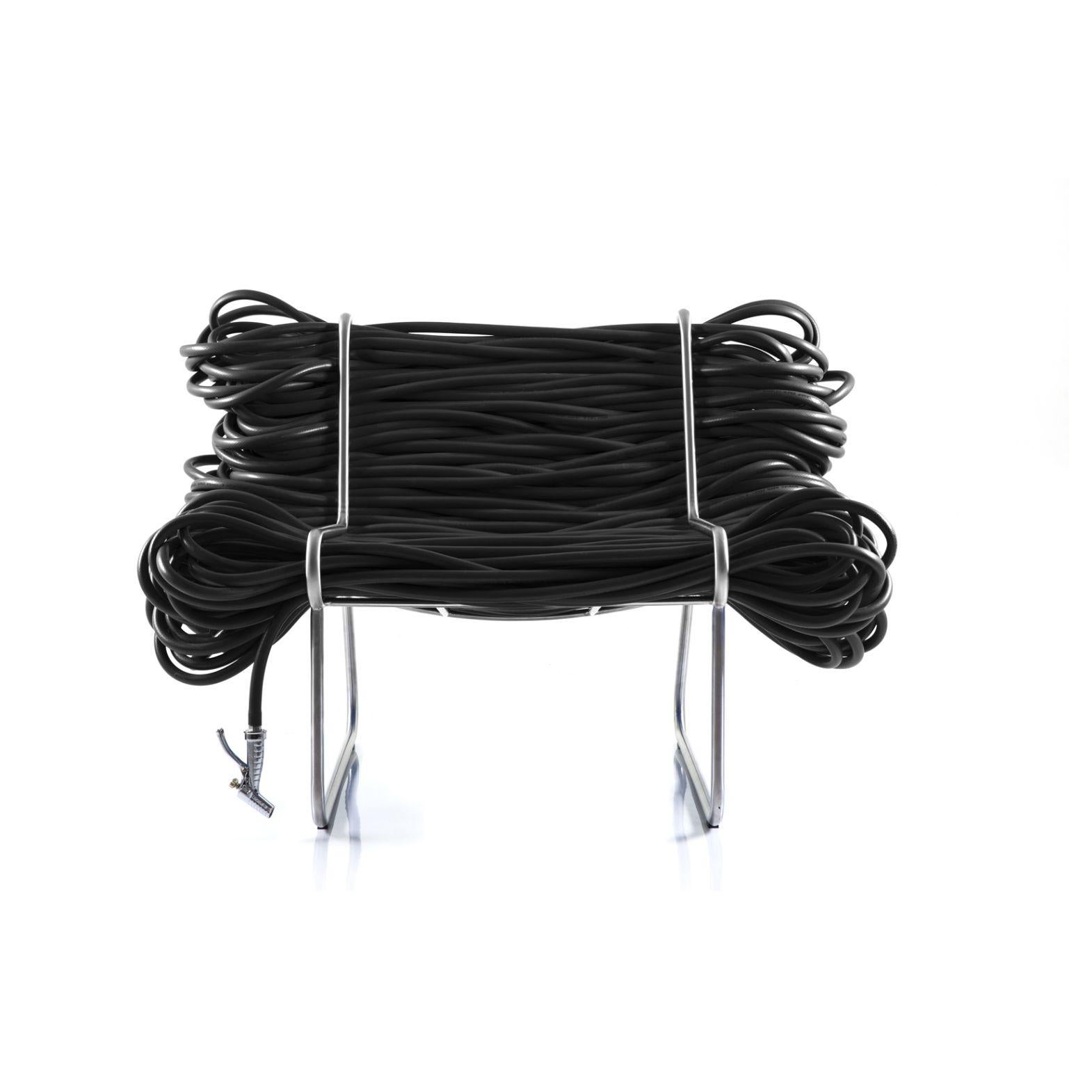 Super Jardim - black armchair by Cultivado Em Casa.
Dimensions: 105 x 80 x 73 cm.
Materials: Stainless steel, PVC hose, nozzle and faucet.

Also available: Green, red, blue, yellow.

Using a 200-meter continuous garden hose, with a faucet at