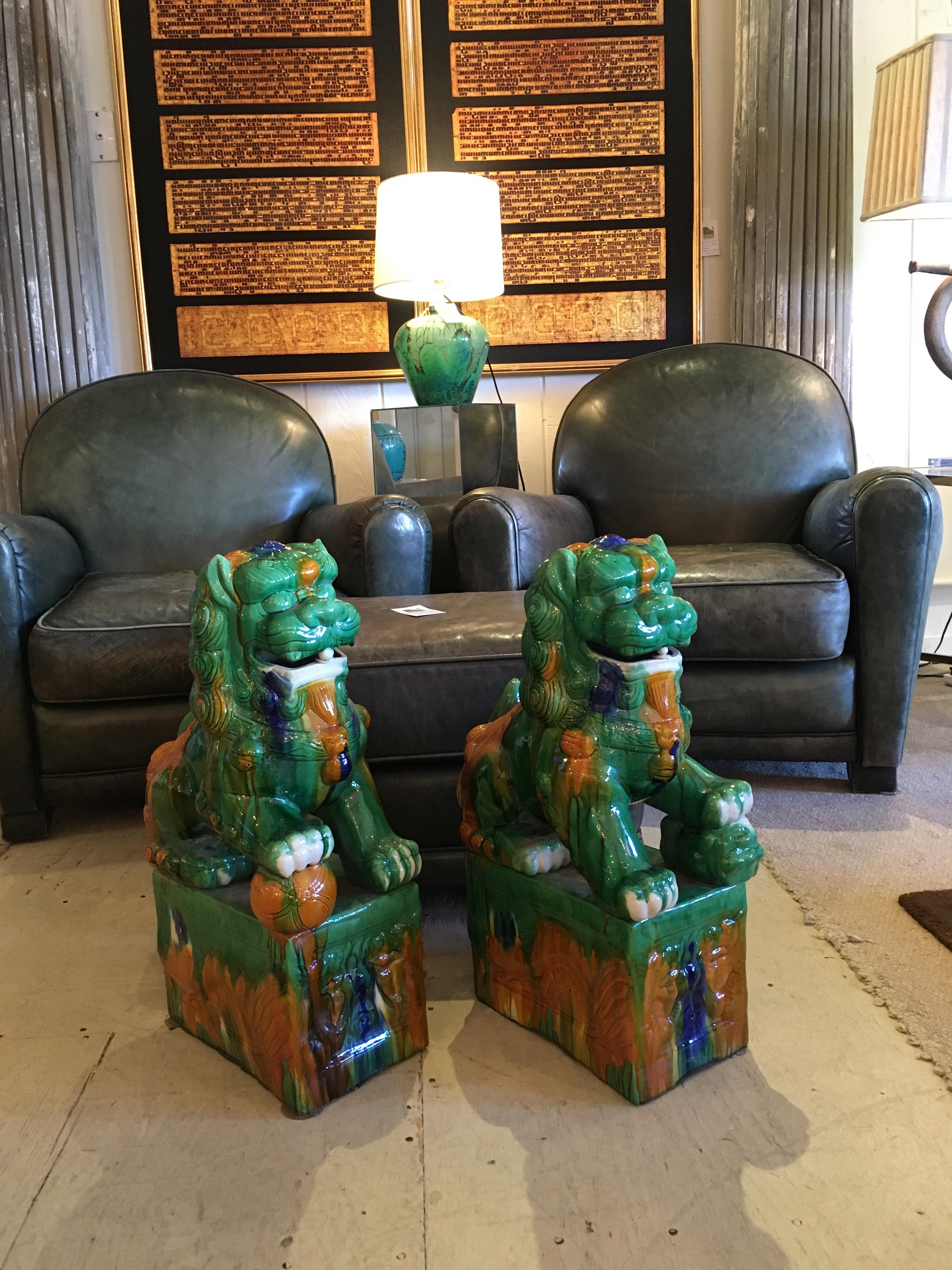 Impressively large pair of striking Asian foo dogs with a gorgeous green and gold glaze.
