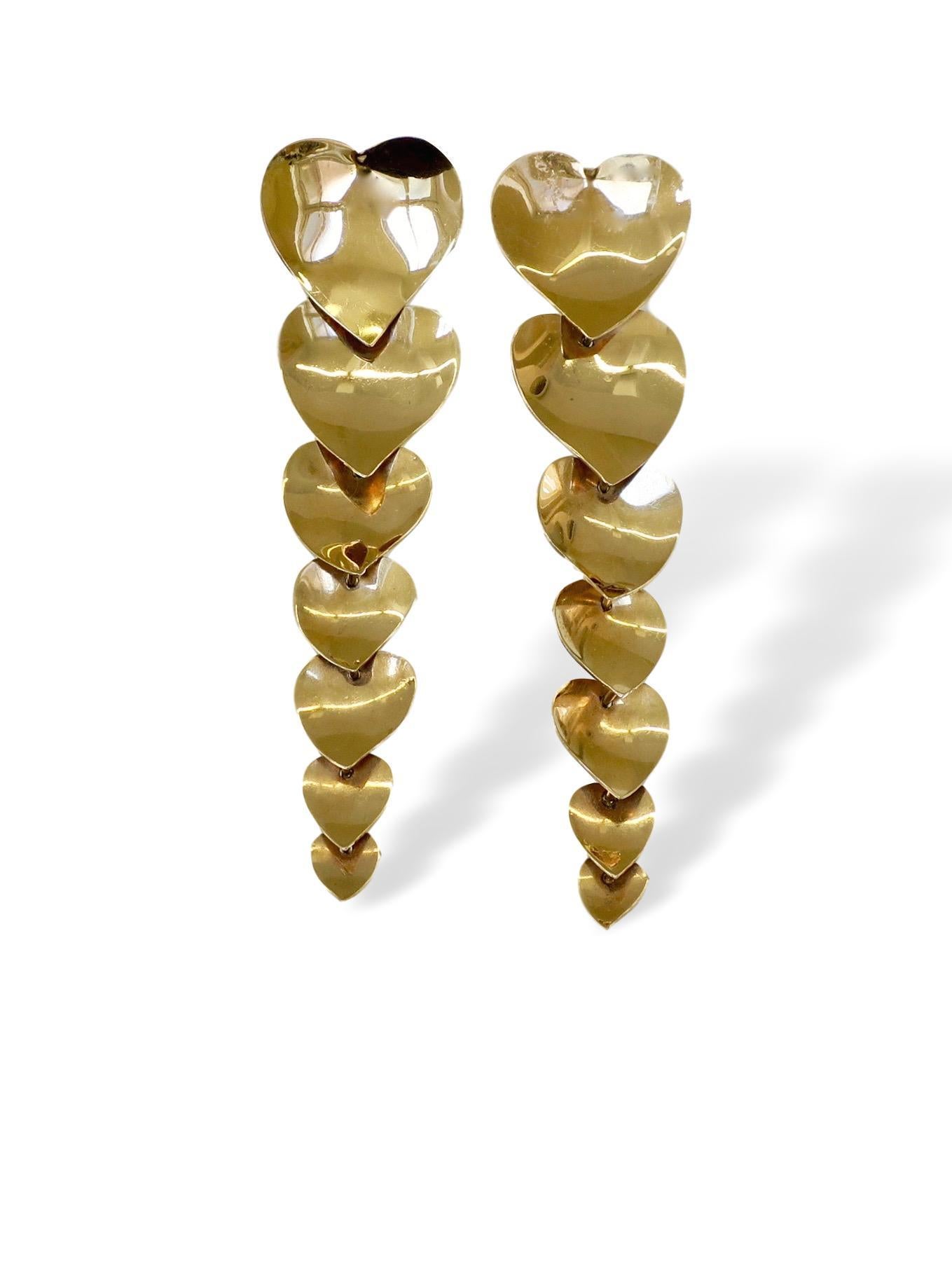 A charming pair of 14k yellow gold Heart- shaped earrings. The 14k mirror-finished gold post earrings made up of 7 graduated and articulated hearts ranging in size from 3/4