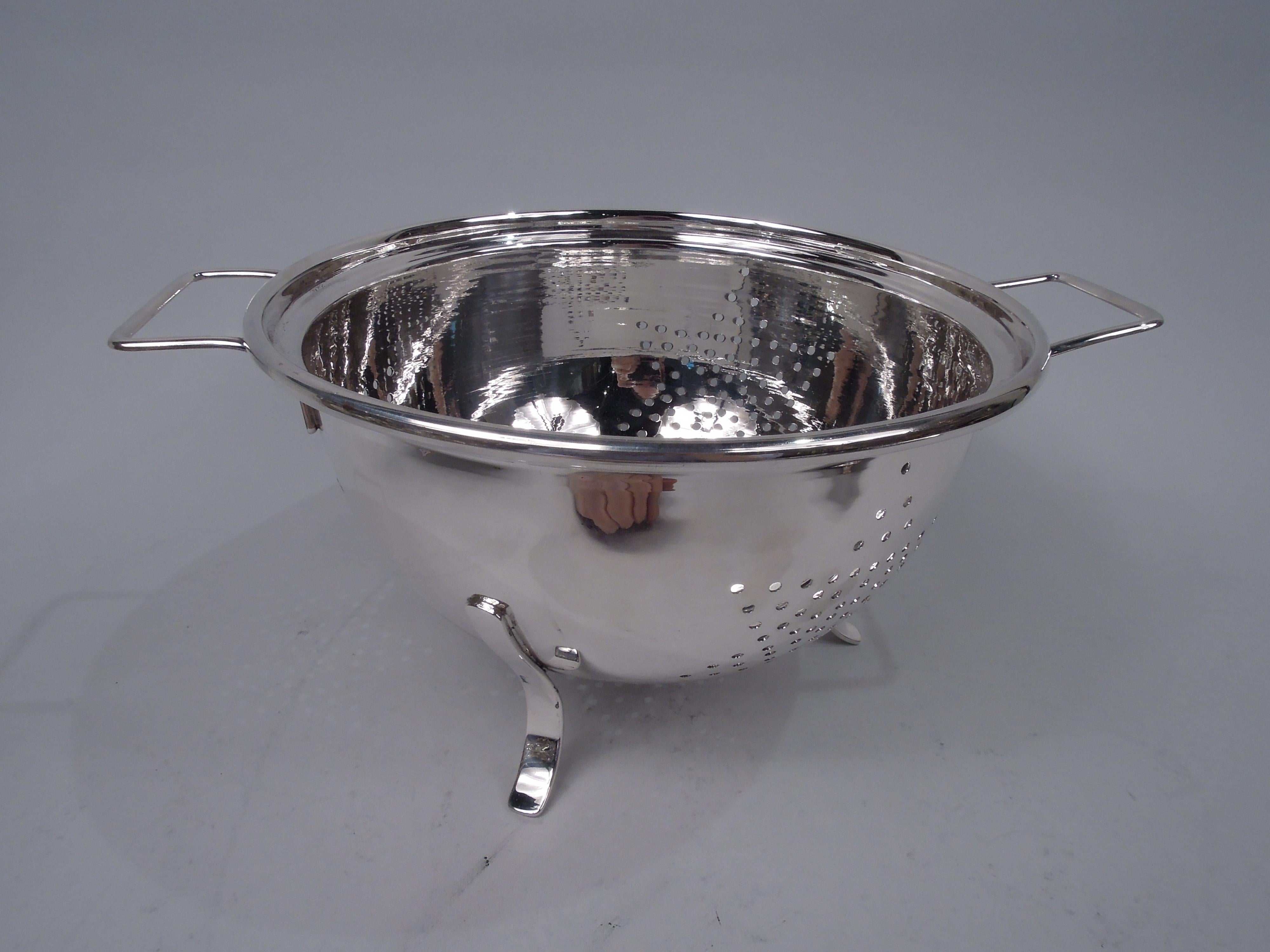 Super luxurious Modern sterling silver colander. Retailed by Cartier in New York. Round bowl with two bracket side handles and 3 scrolled supports. Four pierced stars. A practical kitchen accessory wrought in precious metal. Fully marked including